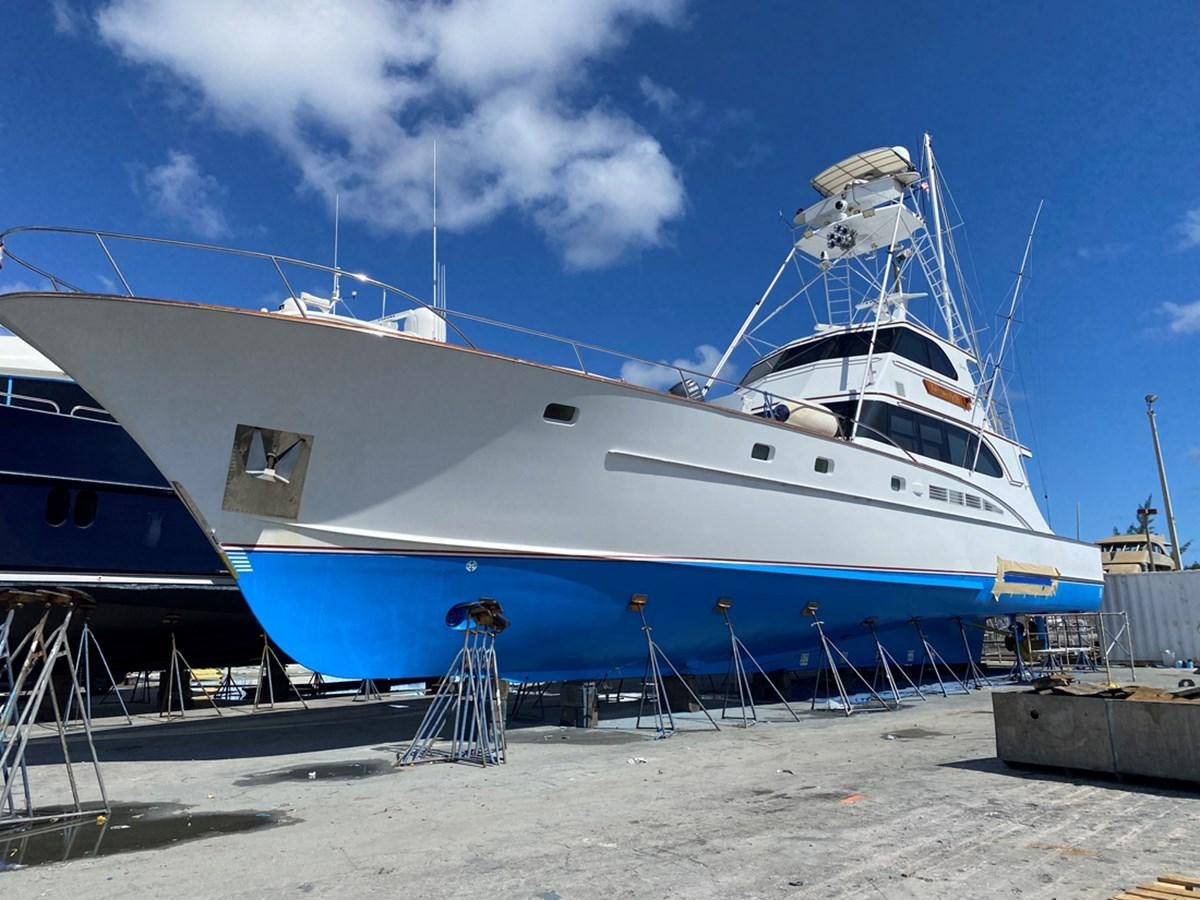 a large white boat on a beach aboard THANKS BUDS Yacht for Sale
