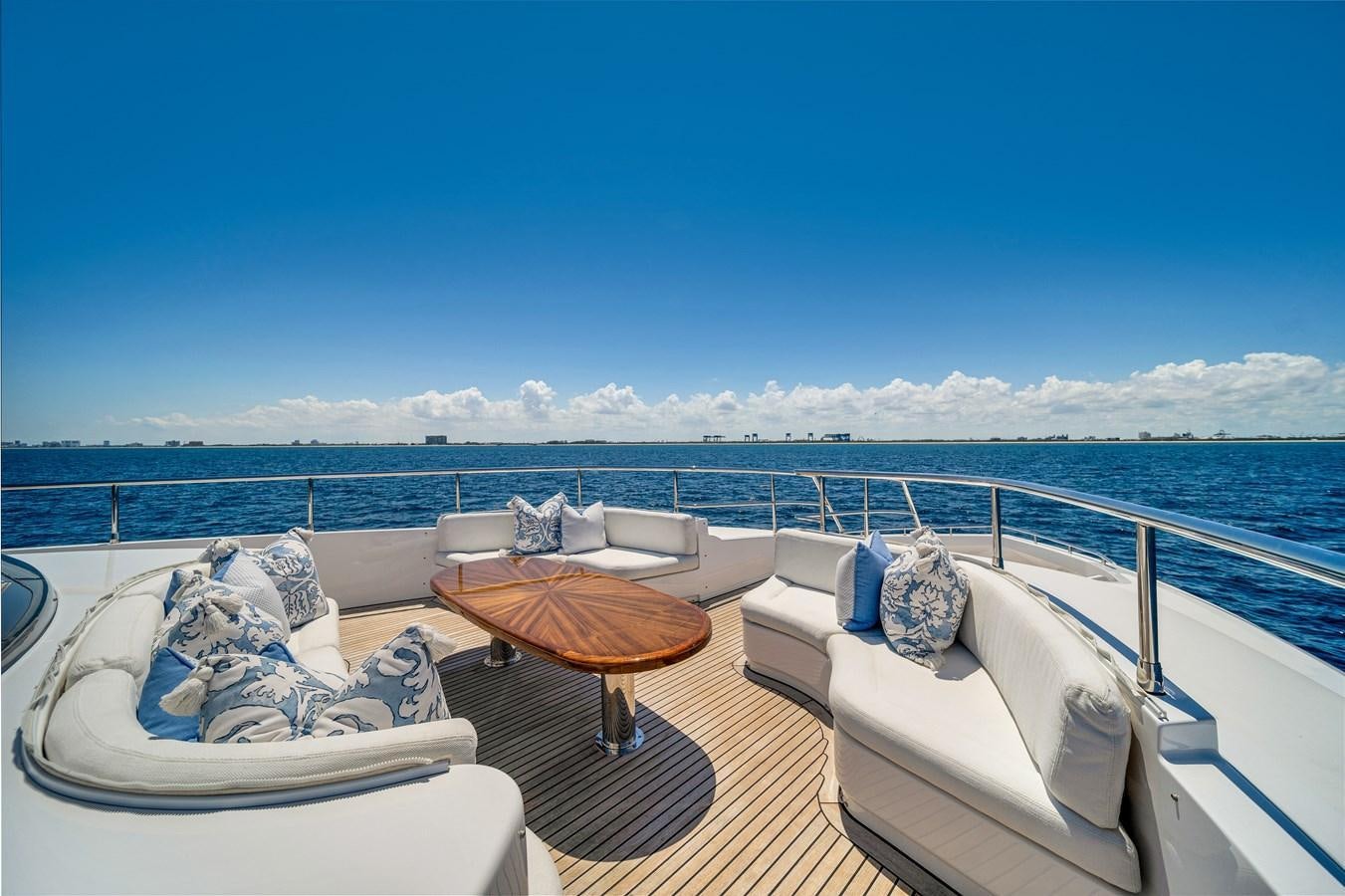 a balcony with a table and chairs aboard FAMILYBILT Yacht for Sale