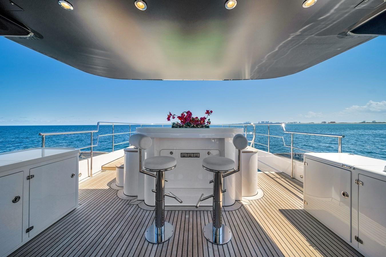 a white table on a balcony overlooking the ocean aboard FAMILYBILT Yacht for Sale