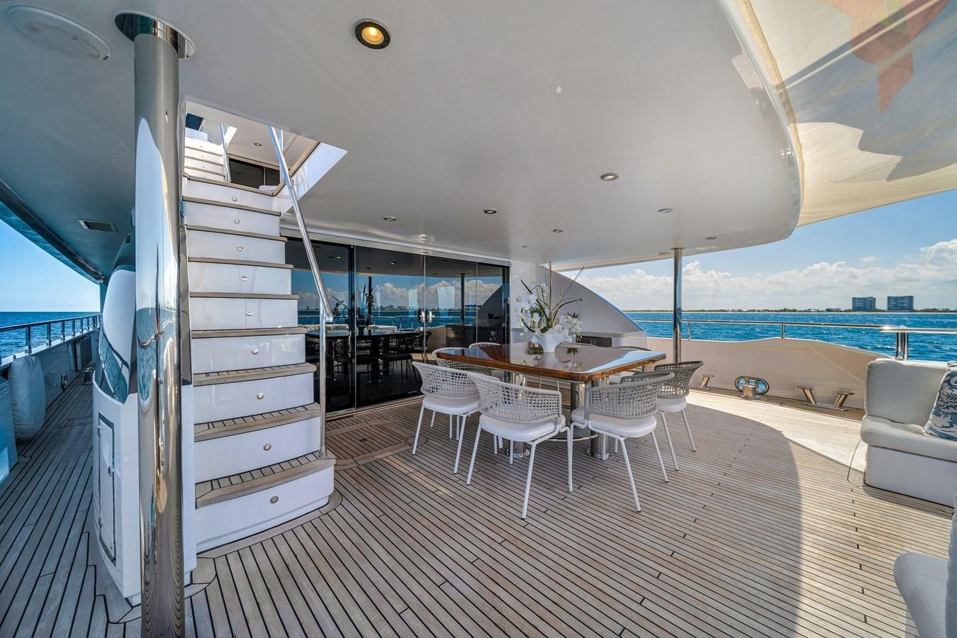 a room with a table chairs and a large window aboard FAMILYBILT Yacht for Sale