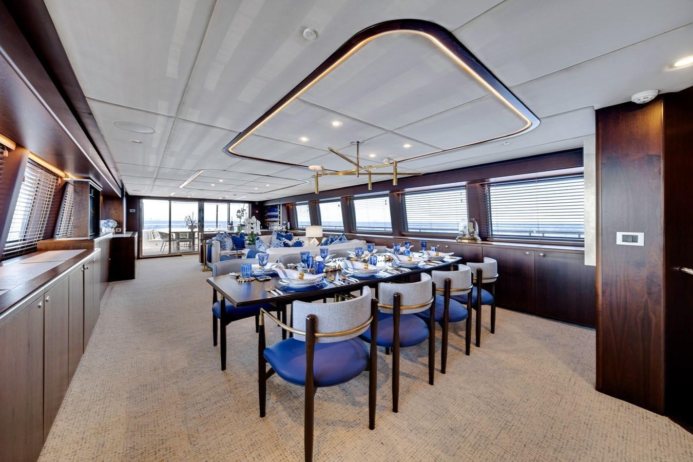 a large kitchen with a table and chairs aboard FAMILYBILT Yacht for Sale