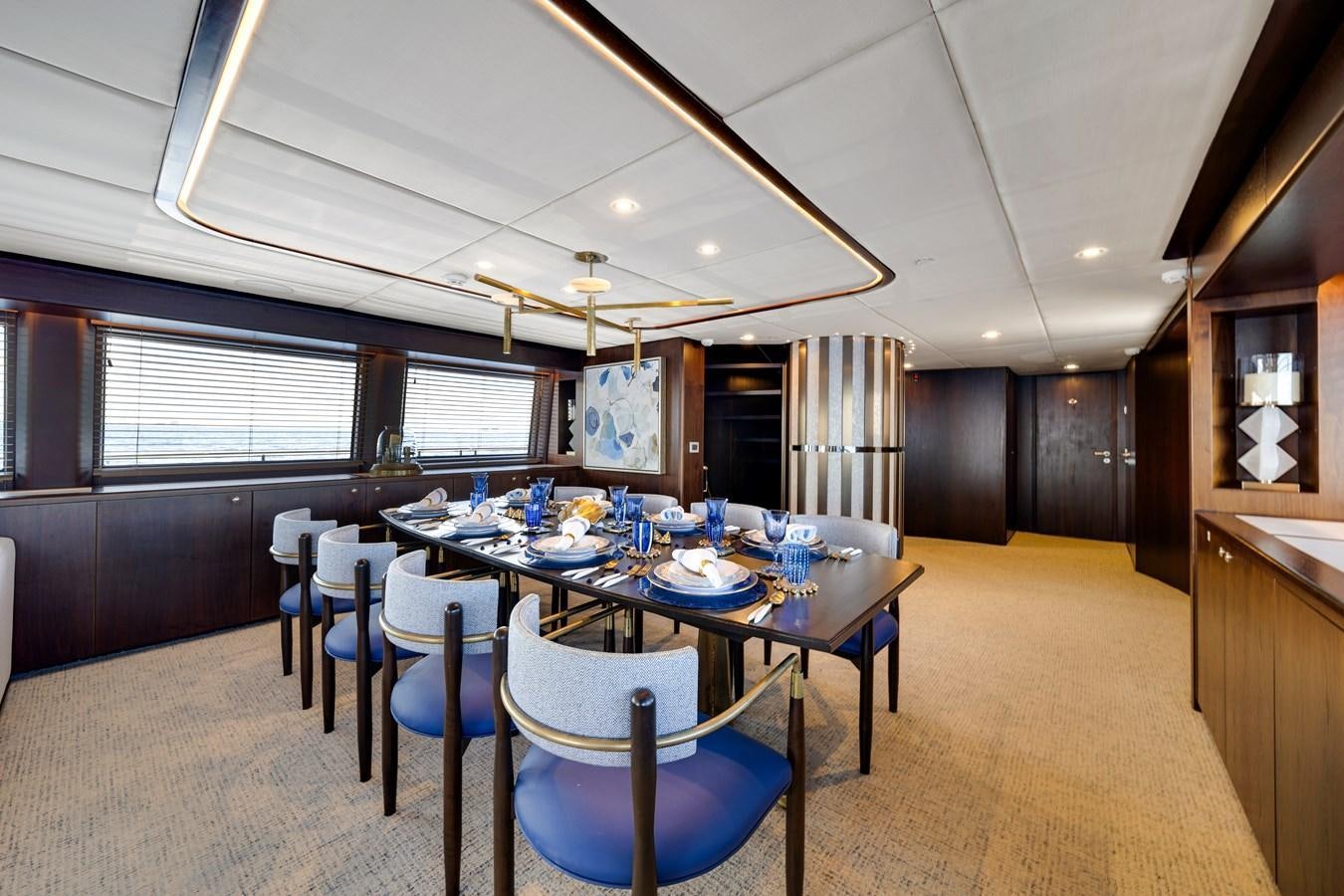 a large dining room with a table and chairs aboard FAMILYBILT Yacht for Sale