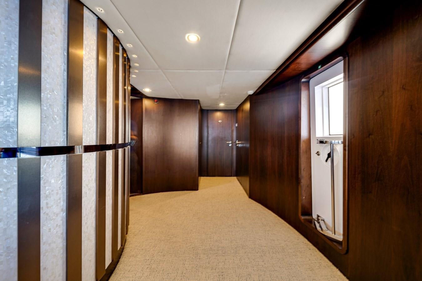 a hallway with a door and a window aboard FAMILYBILT Yacht for Sale