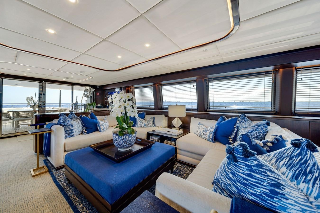 a living room with blue couches aboard FAMILYBILT Yacht for Sale