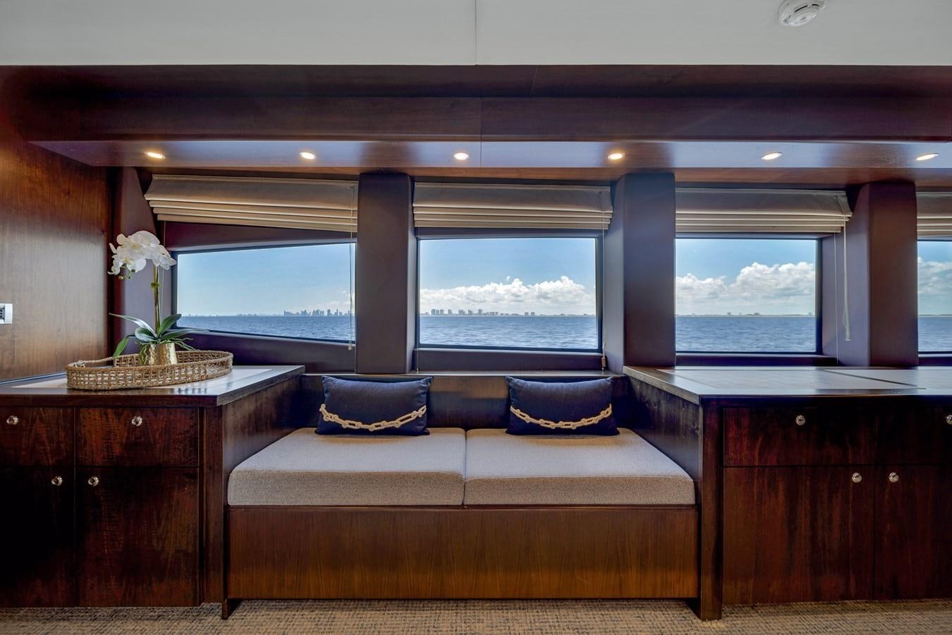 a room with a couch and a large window aboard FAMILYBILT Yacht for Sale