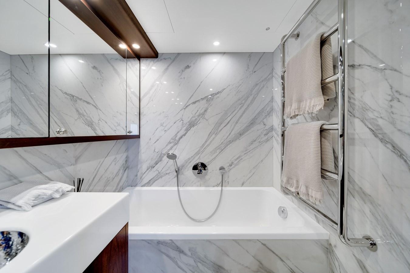 a bathroom with a bathtub and sink aboard FAMILYBILT Yacht for Sale