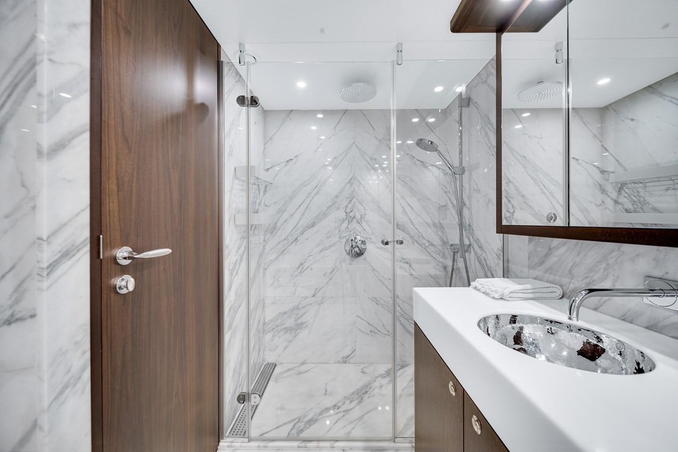 a bathroom with a shower and sink aboard FAMILYBILT Yacht for Sale