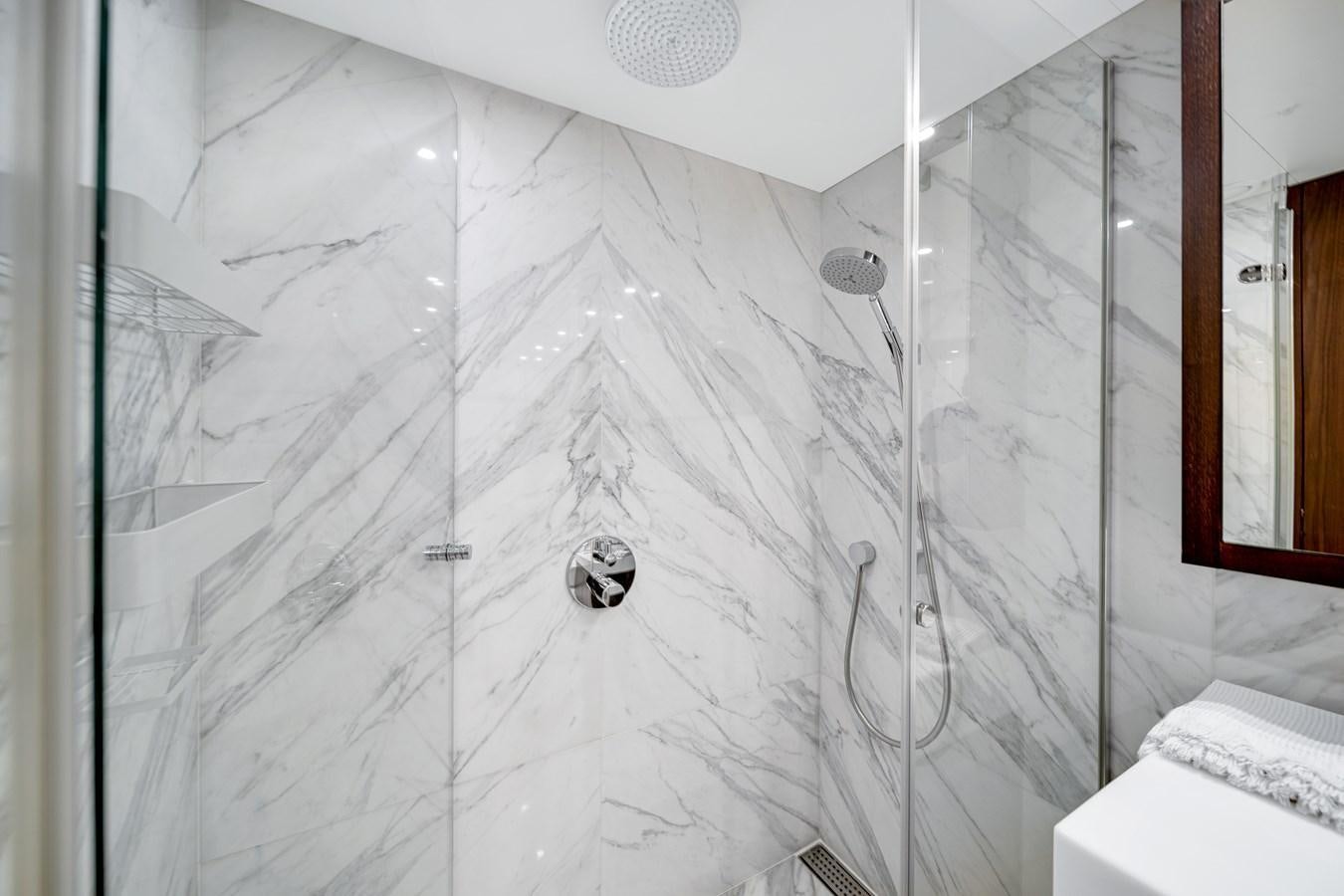 a shower with a glass wall aboard FAMILYBILT Yacht for Sale