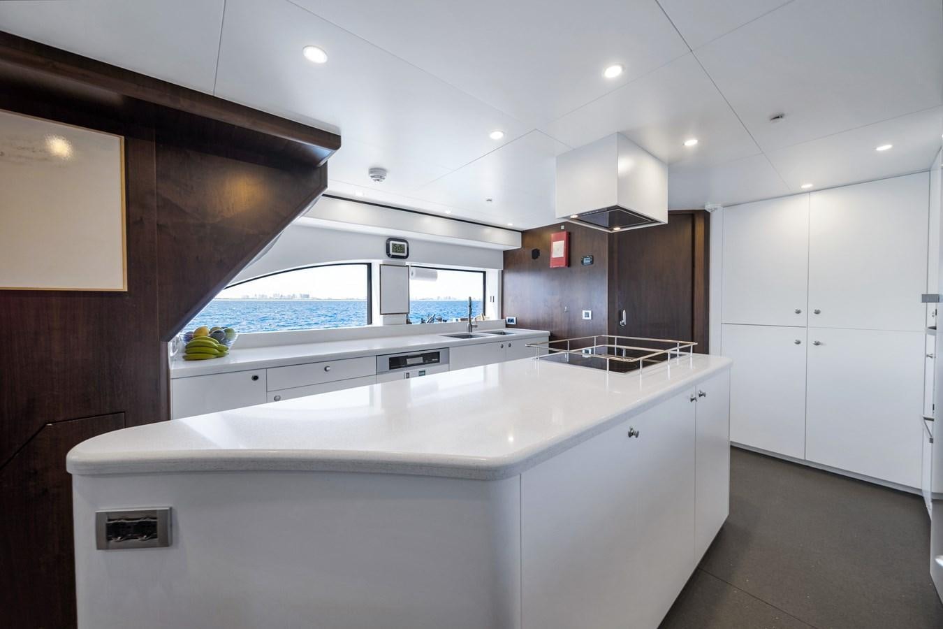 a kitchen with a large window aboard FAMILYBILT Yacht for Sale