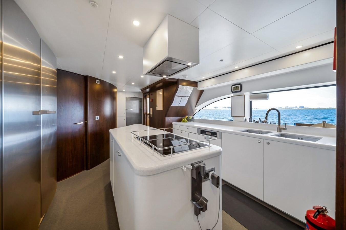 a kitchen with a sink and a washing machine aboard FAMILYBILT Yacht for Sale