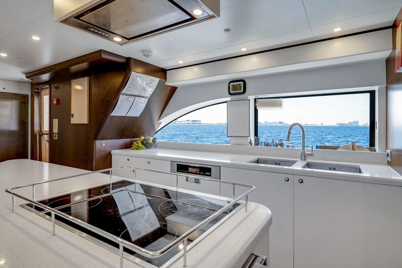 a kitchen with a large window aboard FAMILYBILT Yacht for Sale