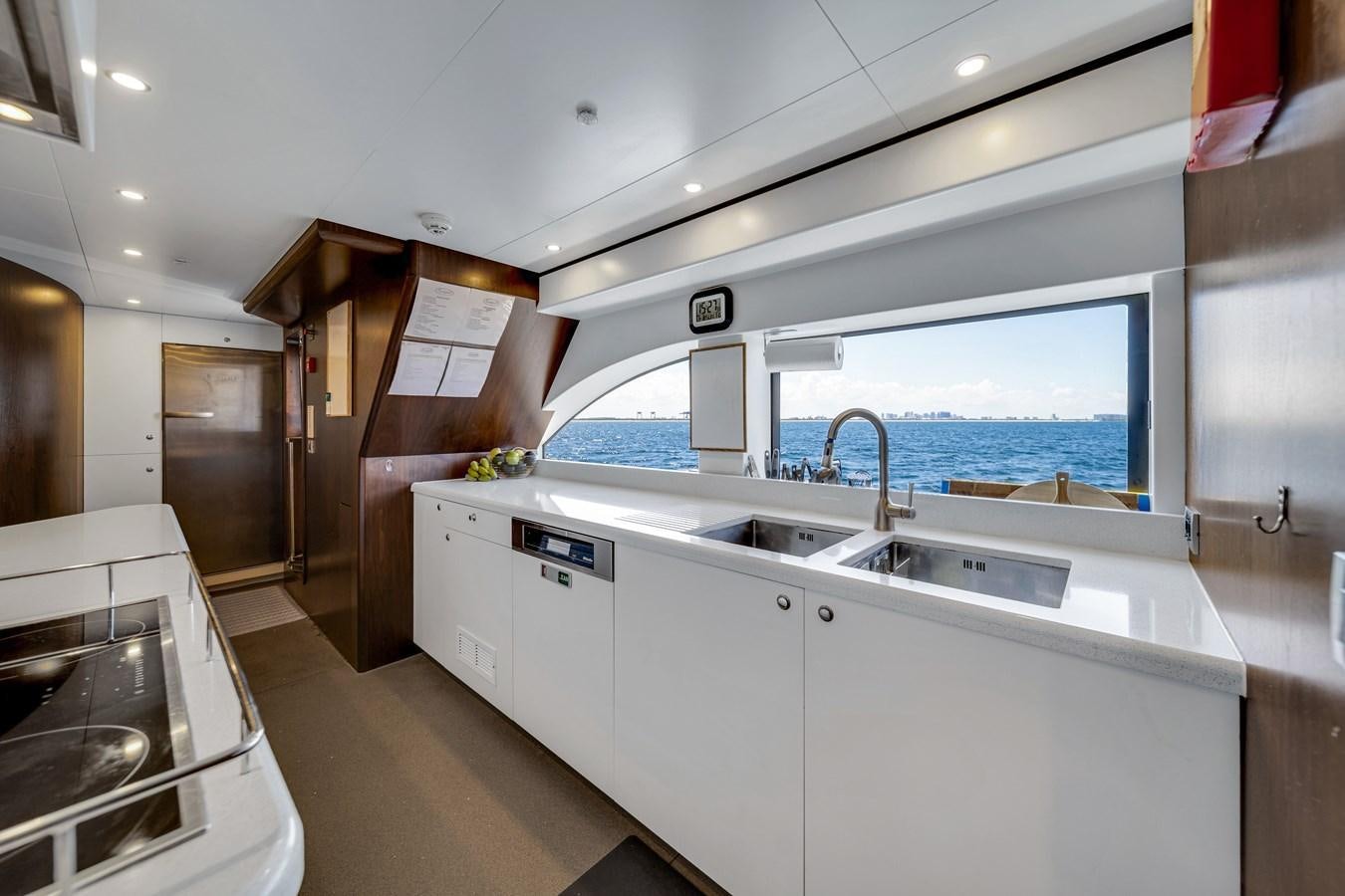 a kitchen with a large window aboard FAMILYBILT Yacht for Sale
