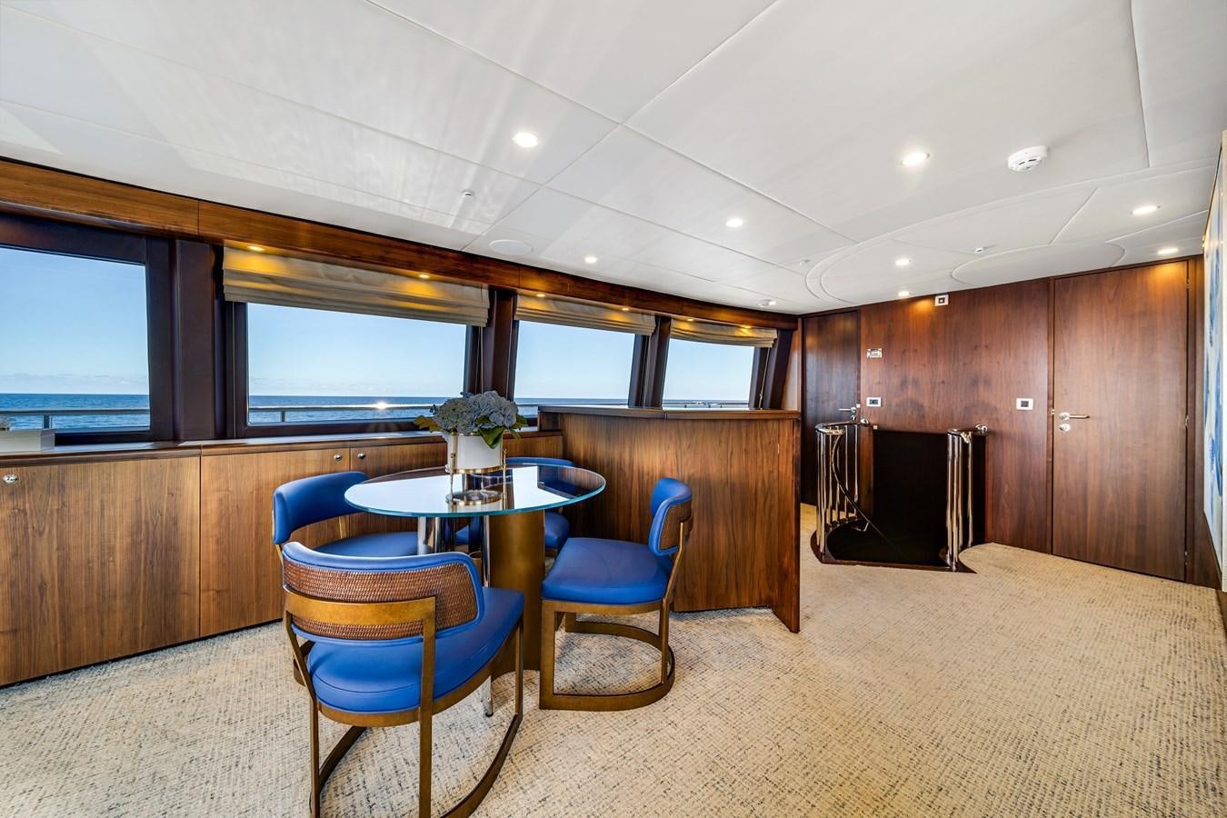 a room with a table and chairs aboard FAMILYBILT Yacht for Sale