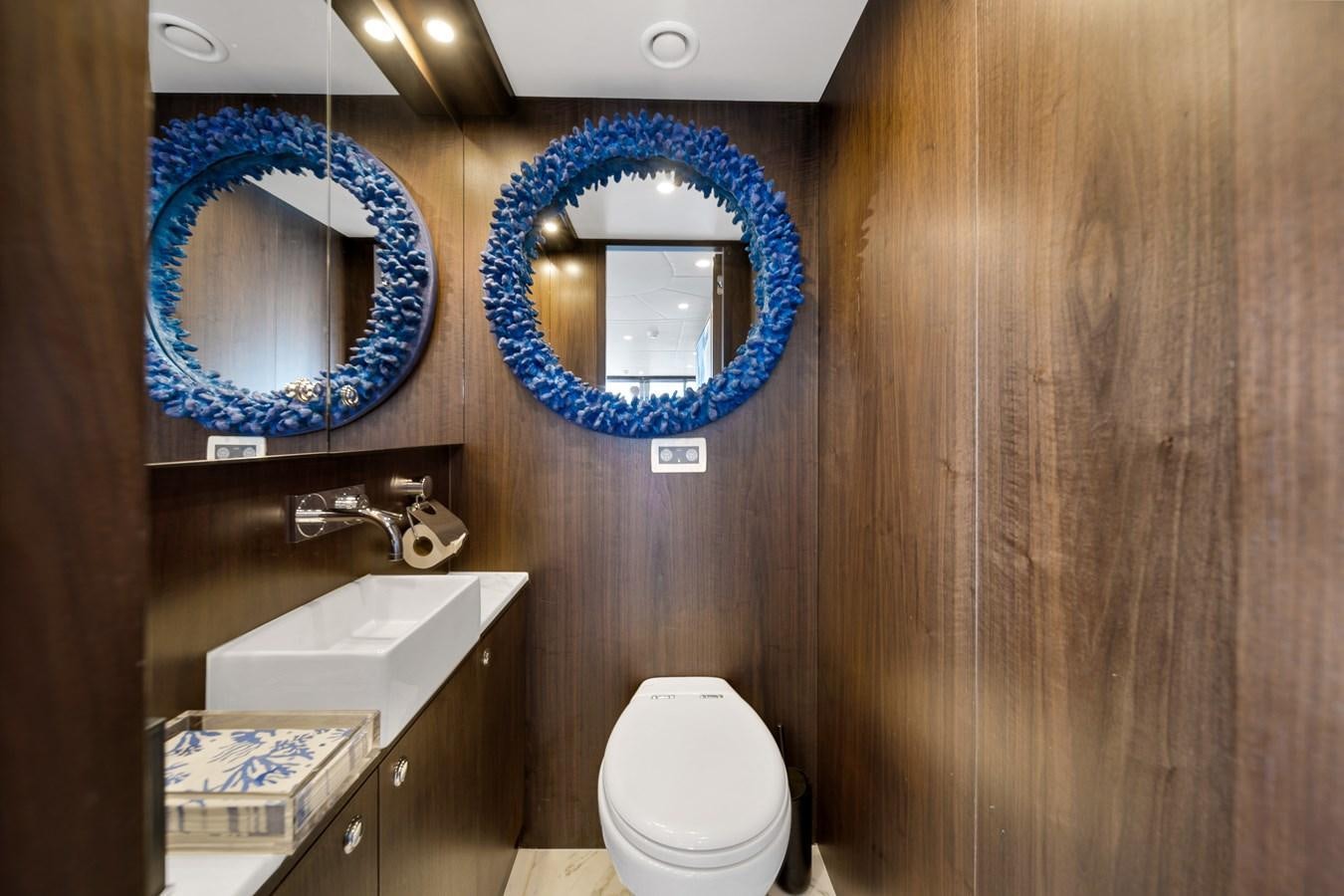 a bathroom with a toilet and a sink aboard FAMILYBILT Yacht for Sale