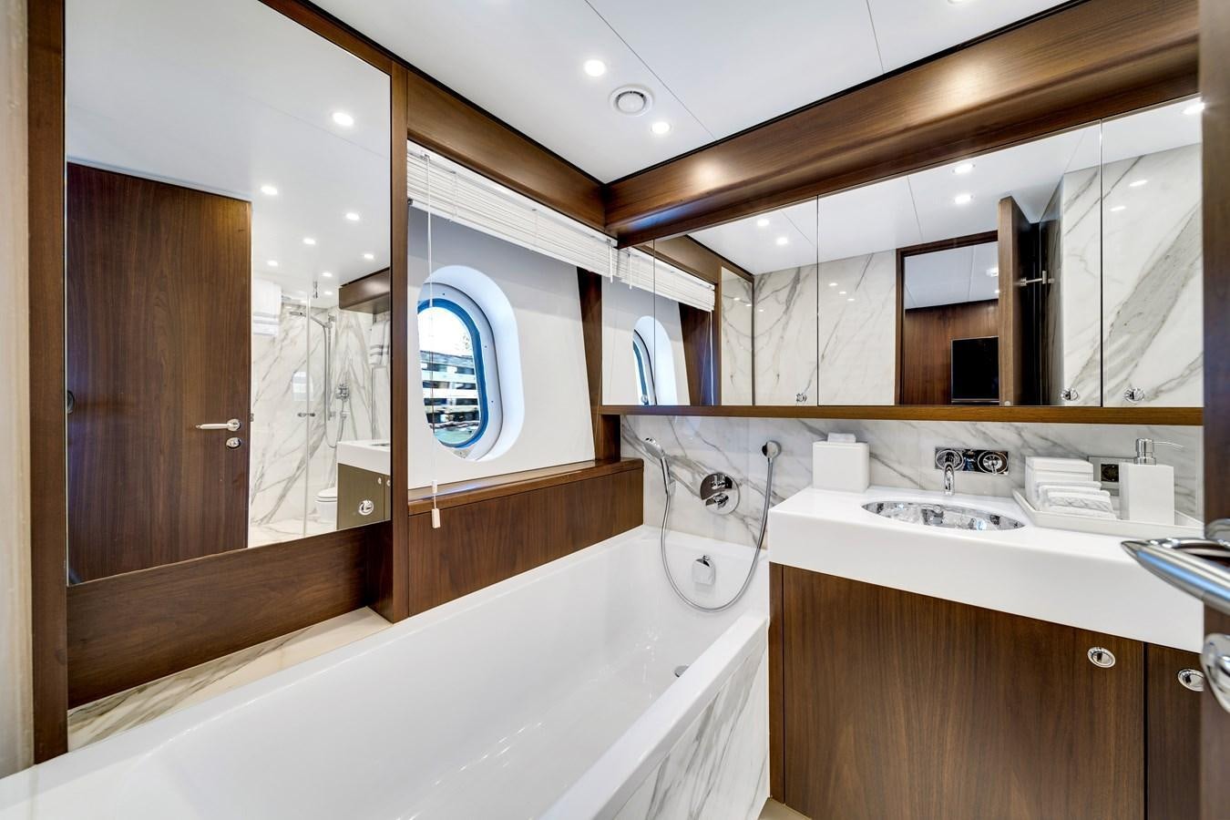 a bathroom with a bathtub and sink aboard FAMILYBILT Yacht for Sale
