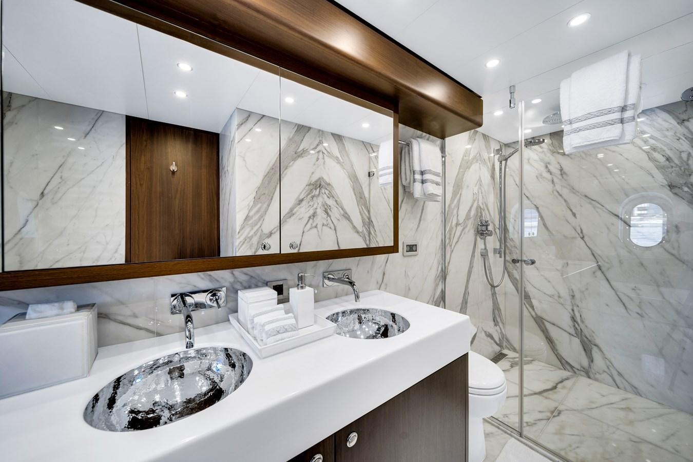 a bathroom with a large mirror aboard FAMILYBILT Yacht for Sale