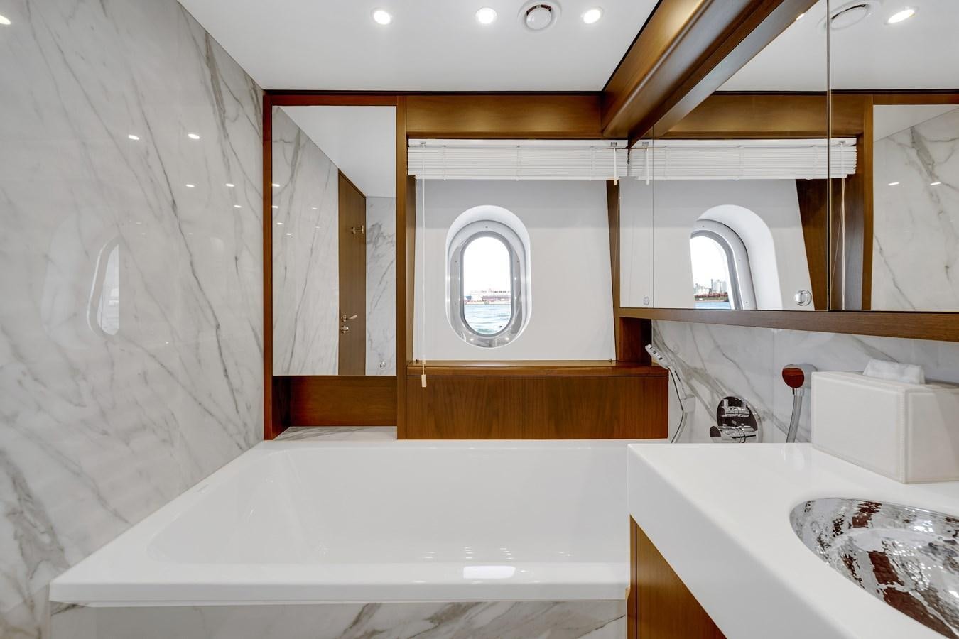 a bathroom with a tub and a toilet aboard FAMILYBILT Yacht for Sale