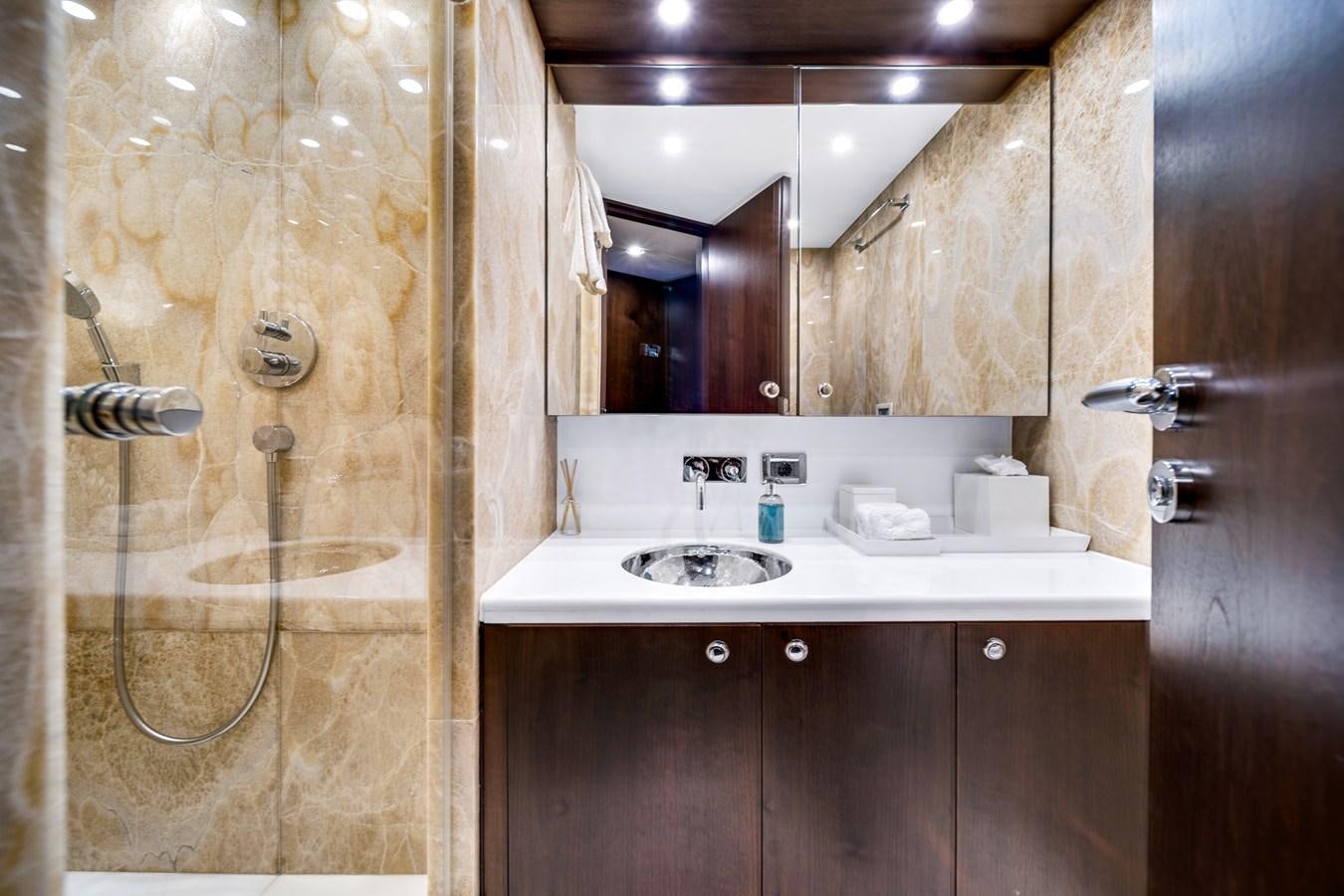 a bathroom with a shower unit and sink aboard FAMILYBILT Yacht for Sale