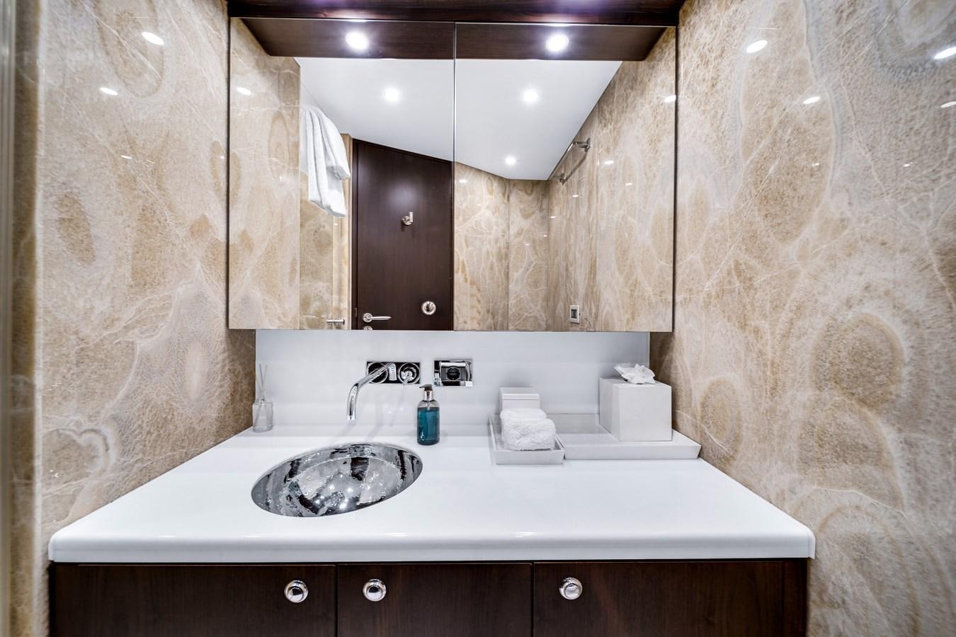 a bathroom with a sink and a mirror aboard FAMILYBILT Yacht for Sale