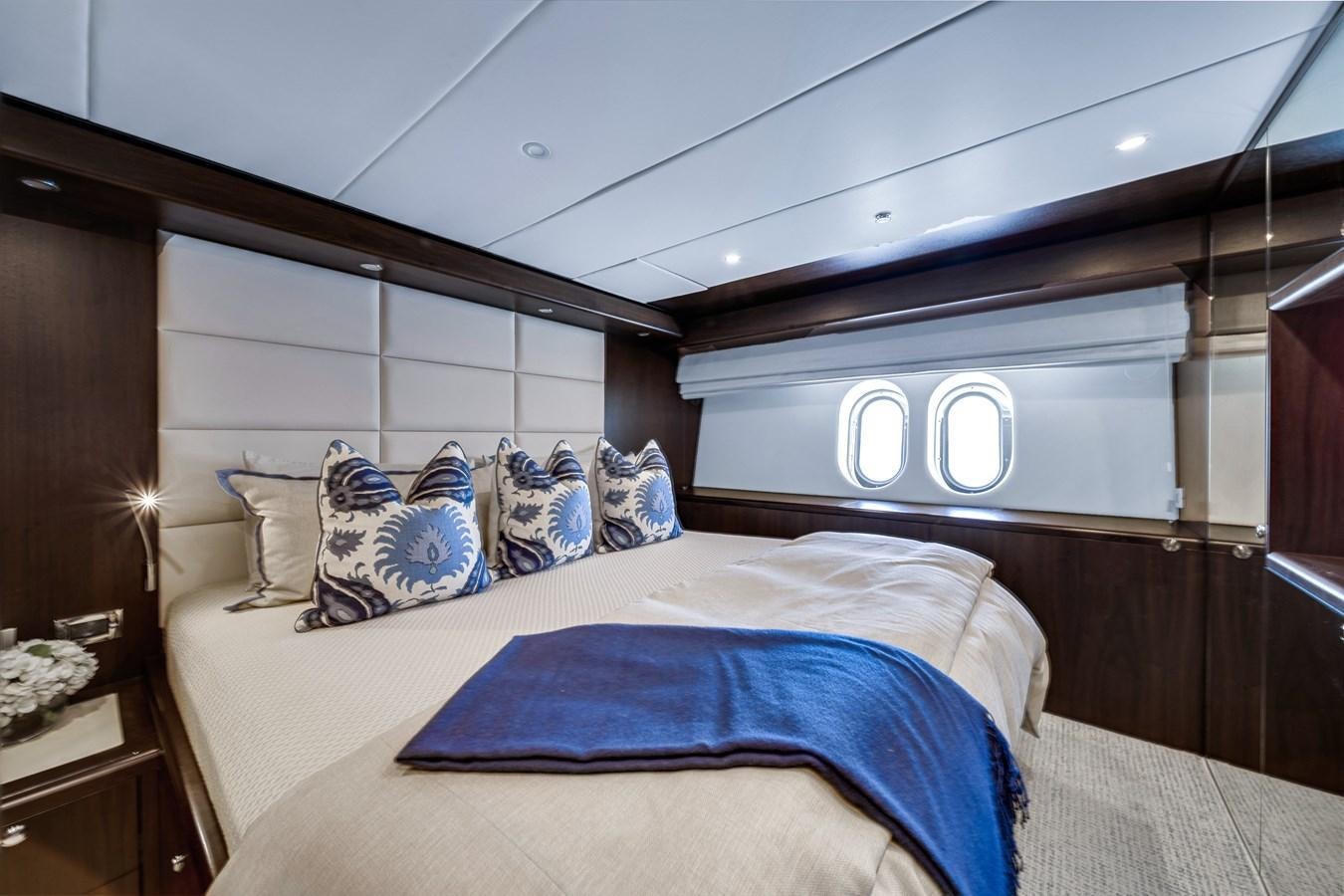 a bed with blue sheets aboard FAMILYBILT Yacht for Sale