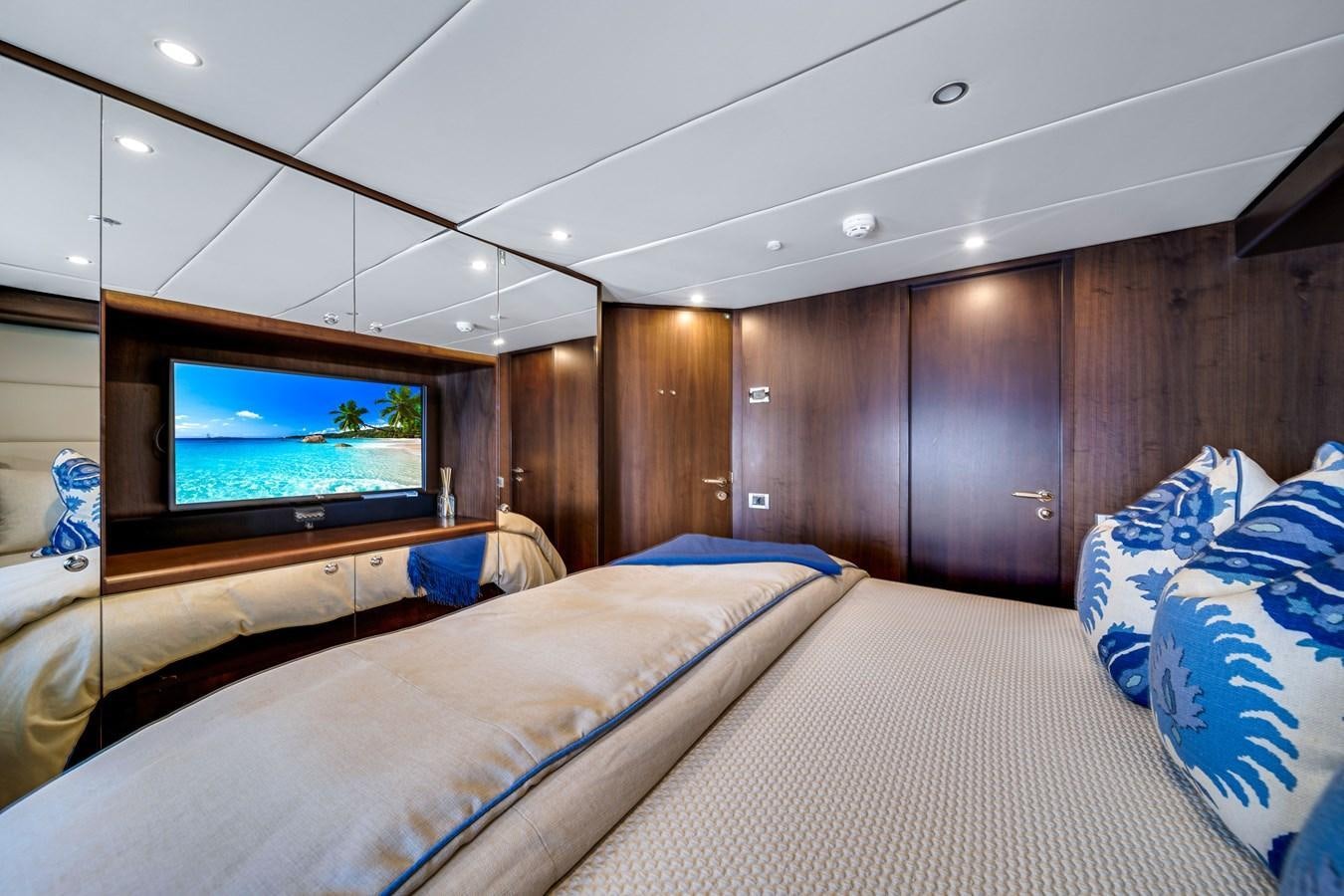 a bedroom with a tv on the wall aboard FAMILYBILT Yacht for Sale