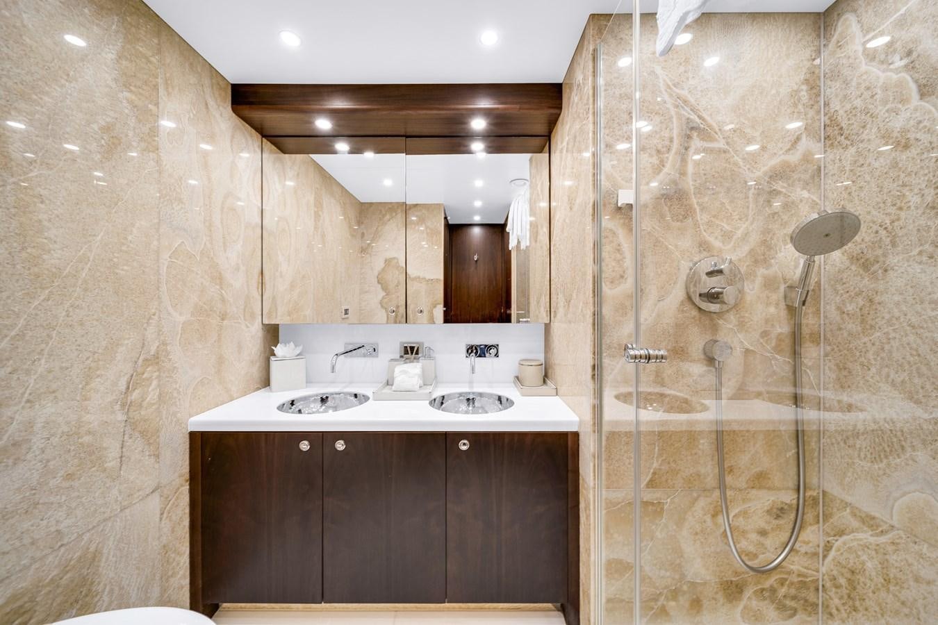 a bathroom with a shower and sink aboard FAMILYBILT Yacht for Sale