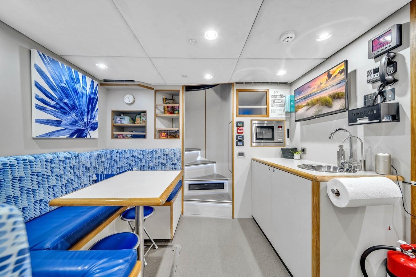 a kitchen with a table and a sink aboard FAMILYBILT Yacht for Sale