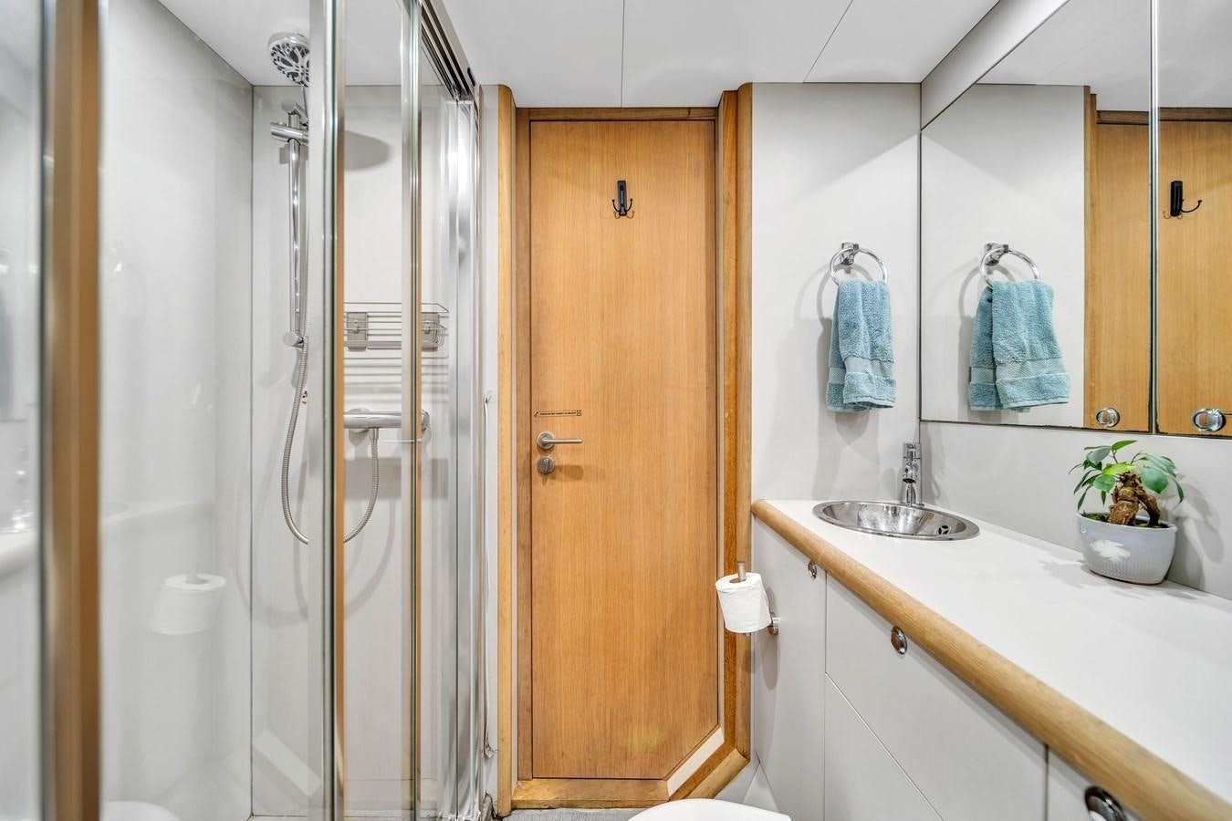 a bathroom with a glass shower aboard FAMILYBILT Yacht for Sale