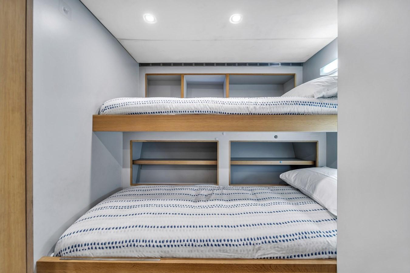 a bed with a white sheet aboard FAMILYBILT Yacht for Sale