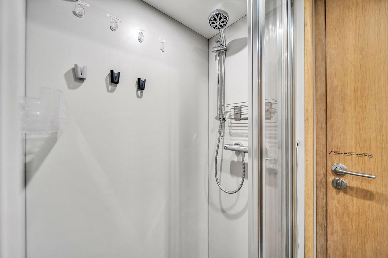 a shower with a glass door aboard FAMILYBILT Yacht for Sale