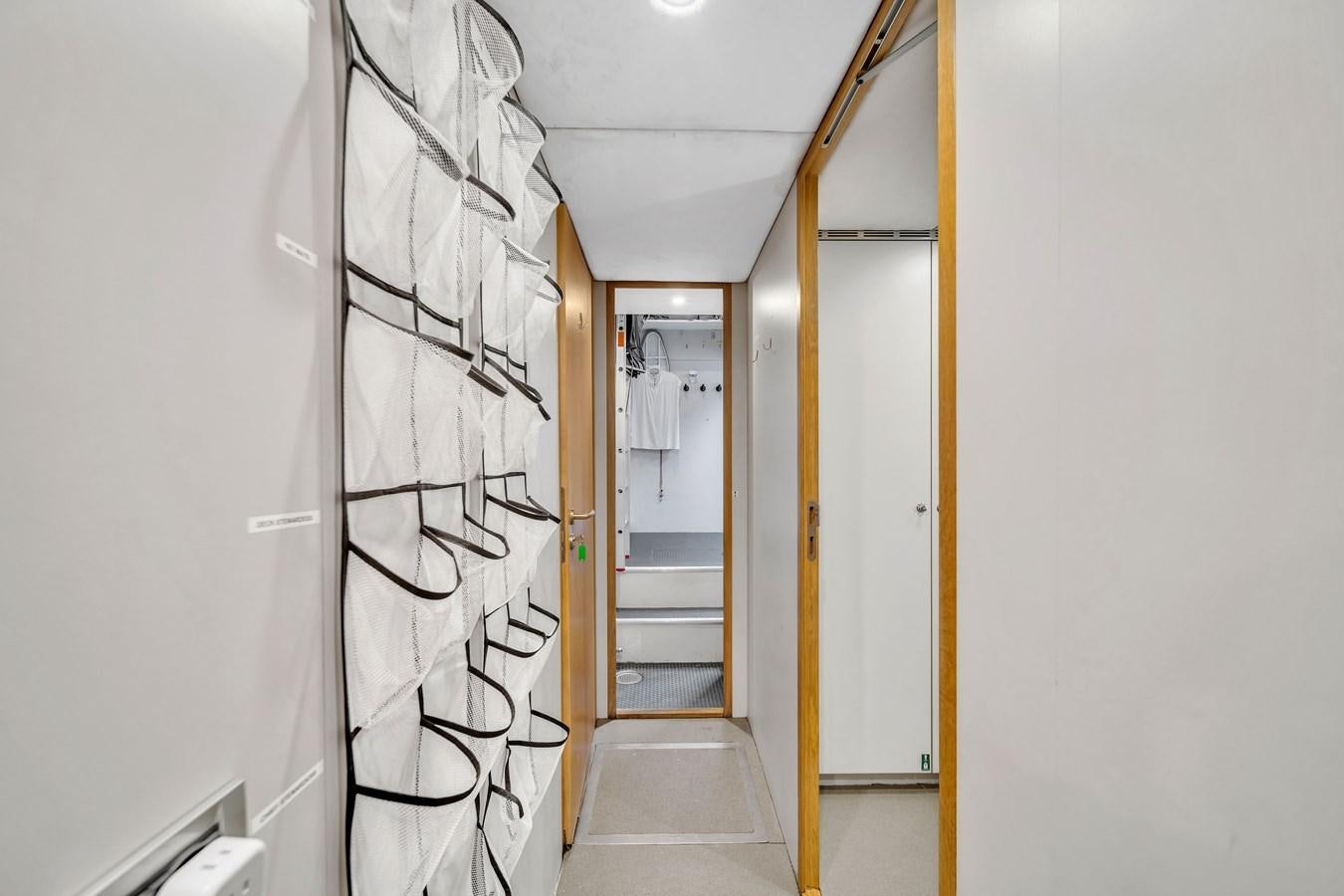 a hallway with a glass door aboard FAMILYBILT Yacht for Sale