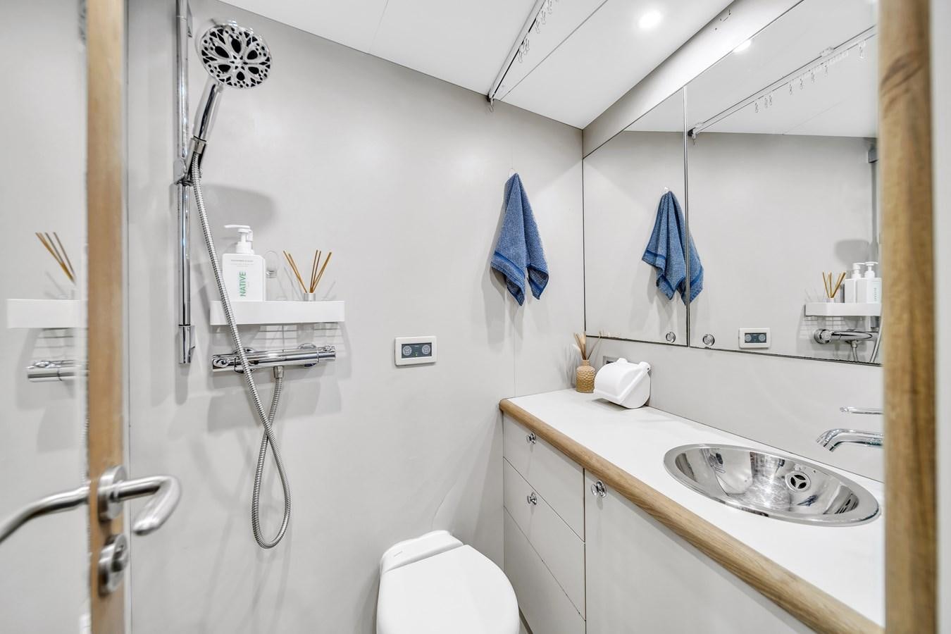 a bathroom with a sink and toilet aboard FAMILYBILT Yacht for Sale
