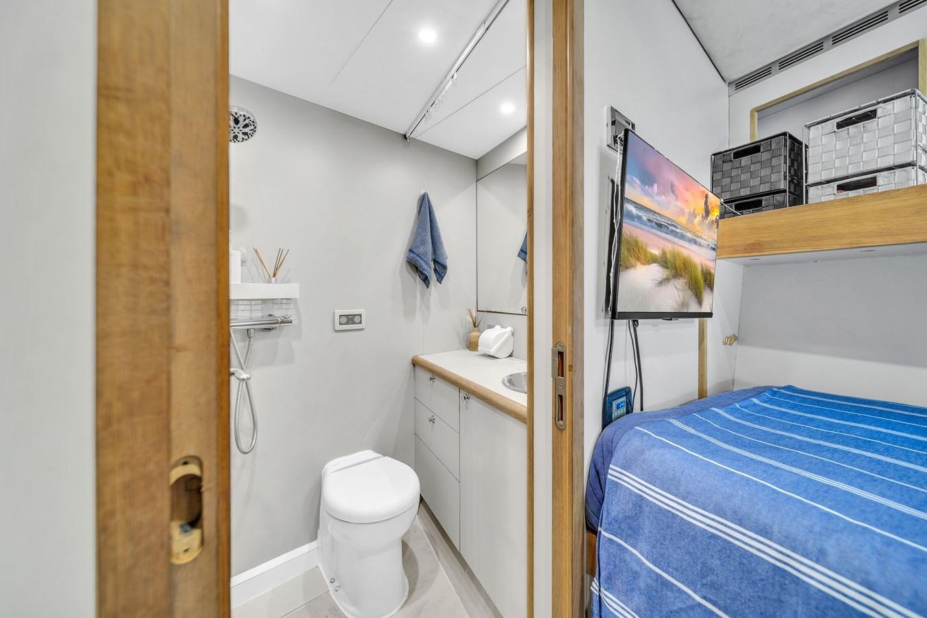 a bathroom with a blue bed sheet aboard FAMILYBILT Yacht for Sale