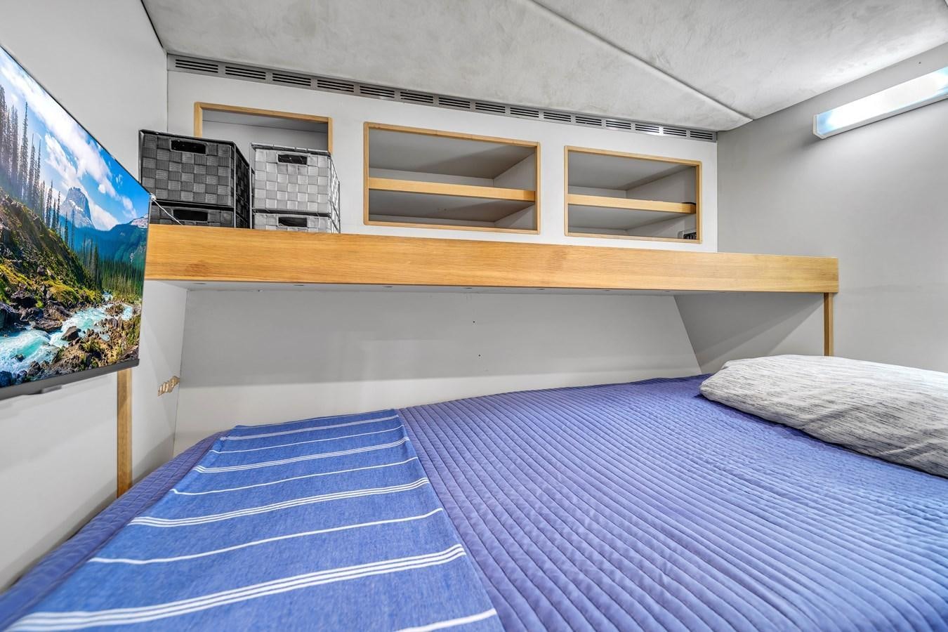 a bed with a blue sheet aboard FAMILYBILT Yacht for Sale