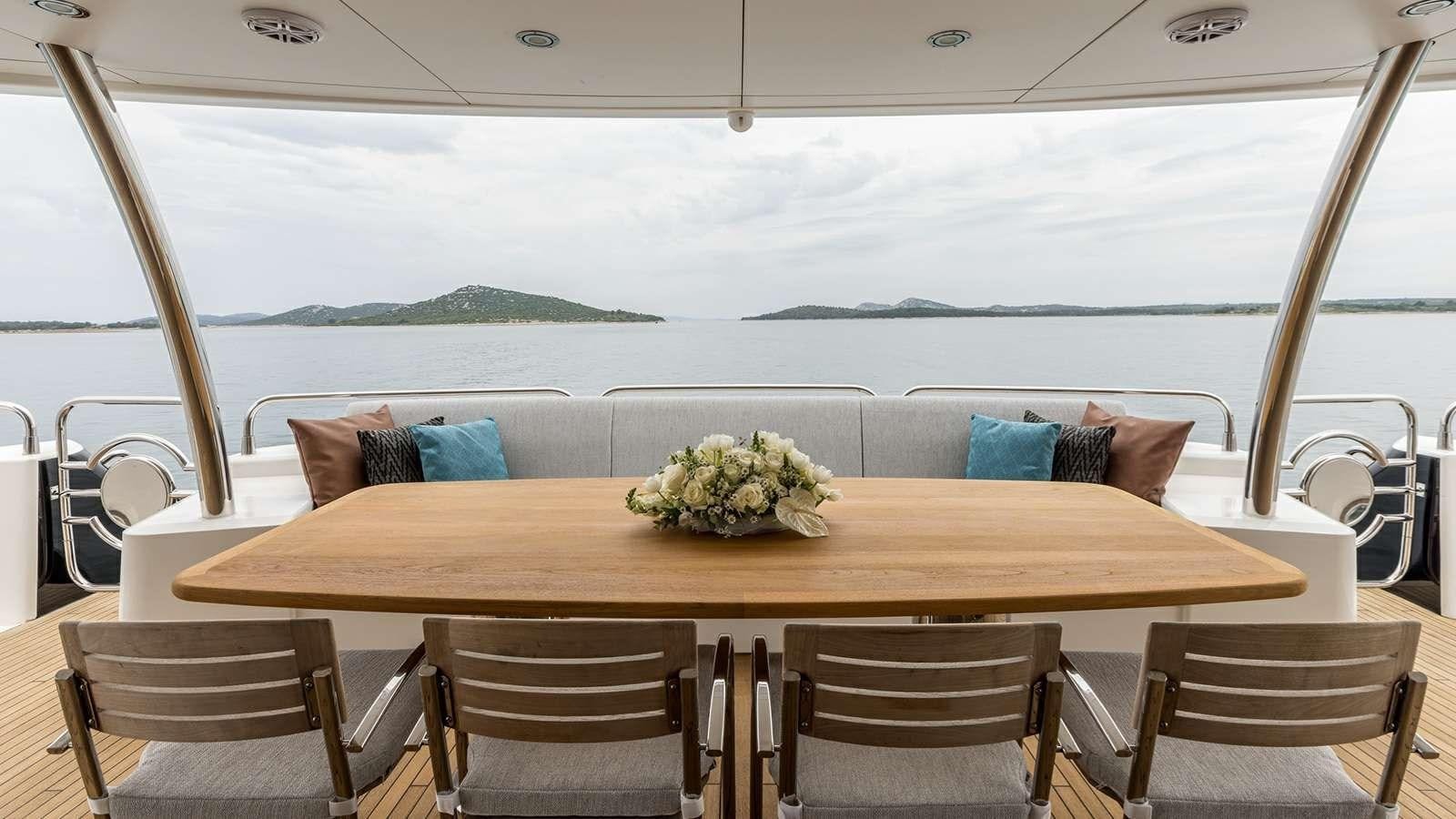 a table with a flower arrangement on it aboard KATARIINA I Yacht for Sale