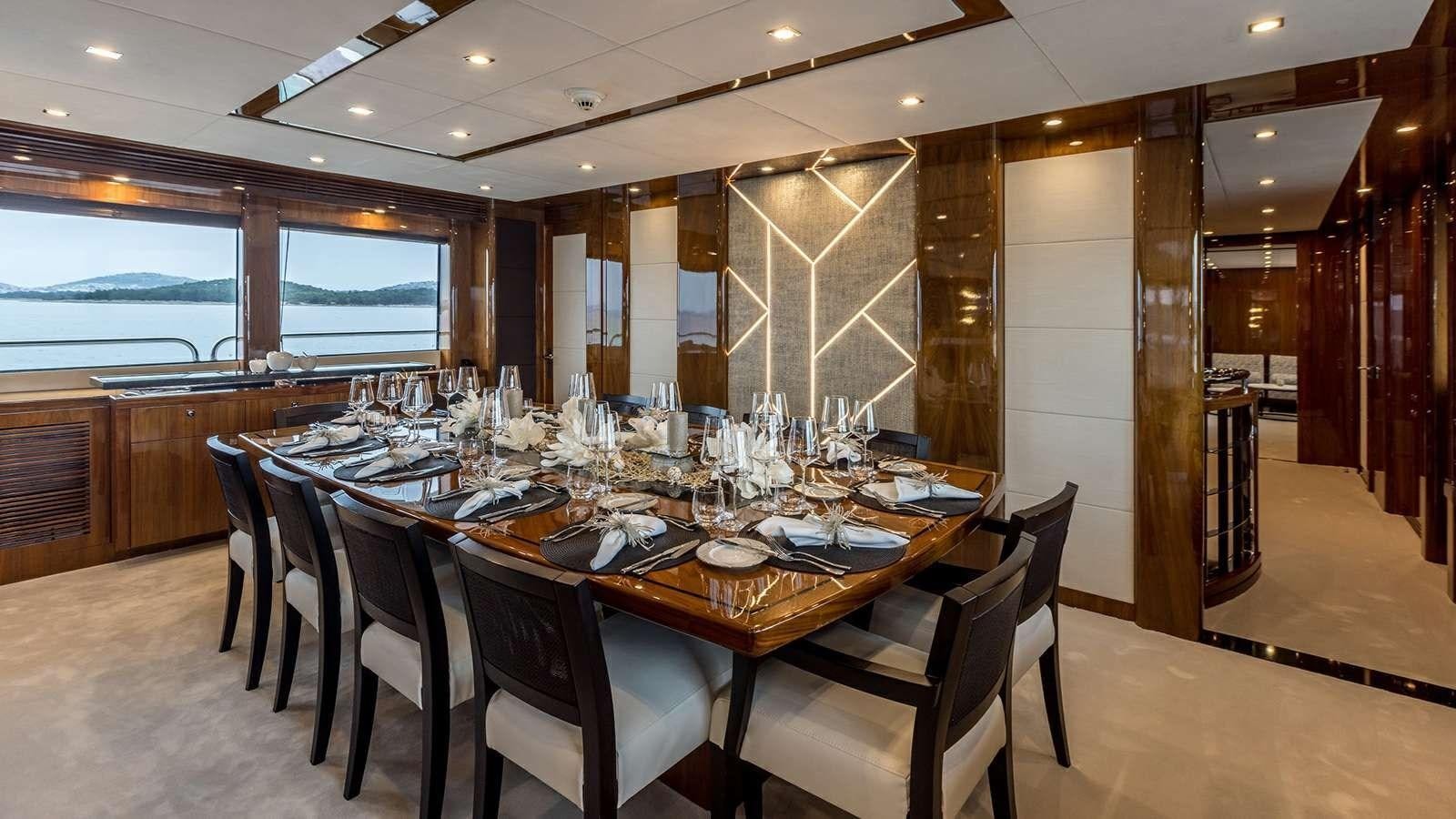 a large dining table in a room aboard KATARIINA I Yacht for Sale