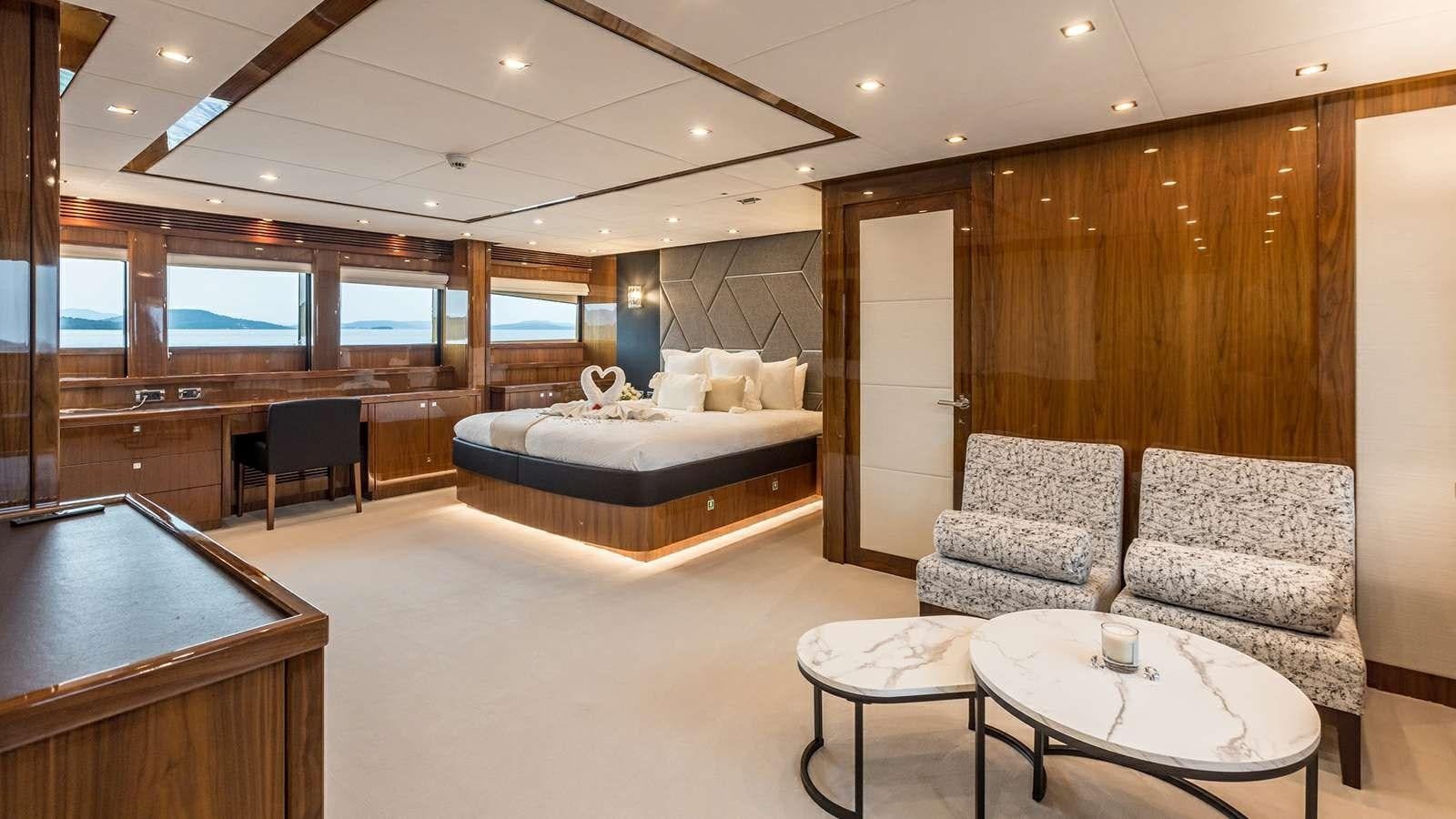 a large room with a bed and a chair aboard KATARIINA I Yacht for Sale