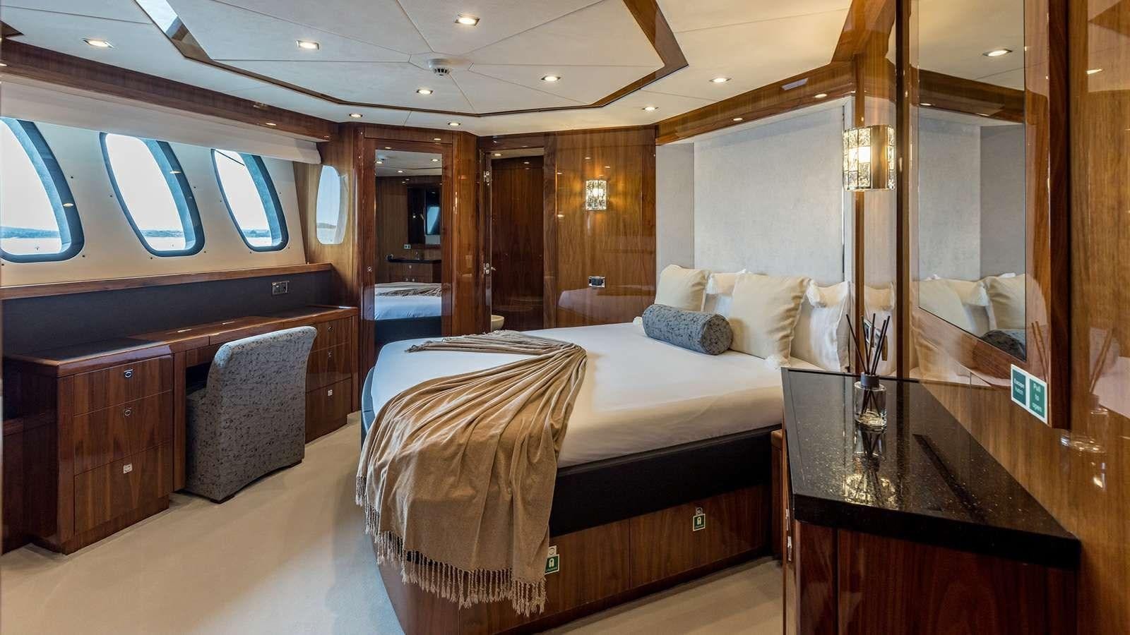 a room with a bed and a desk aboard KATARIINA I Yacht for Sale