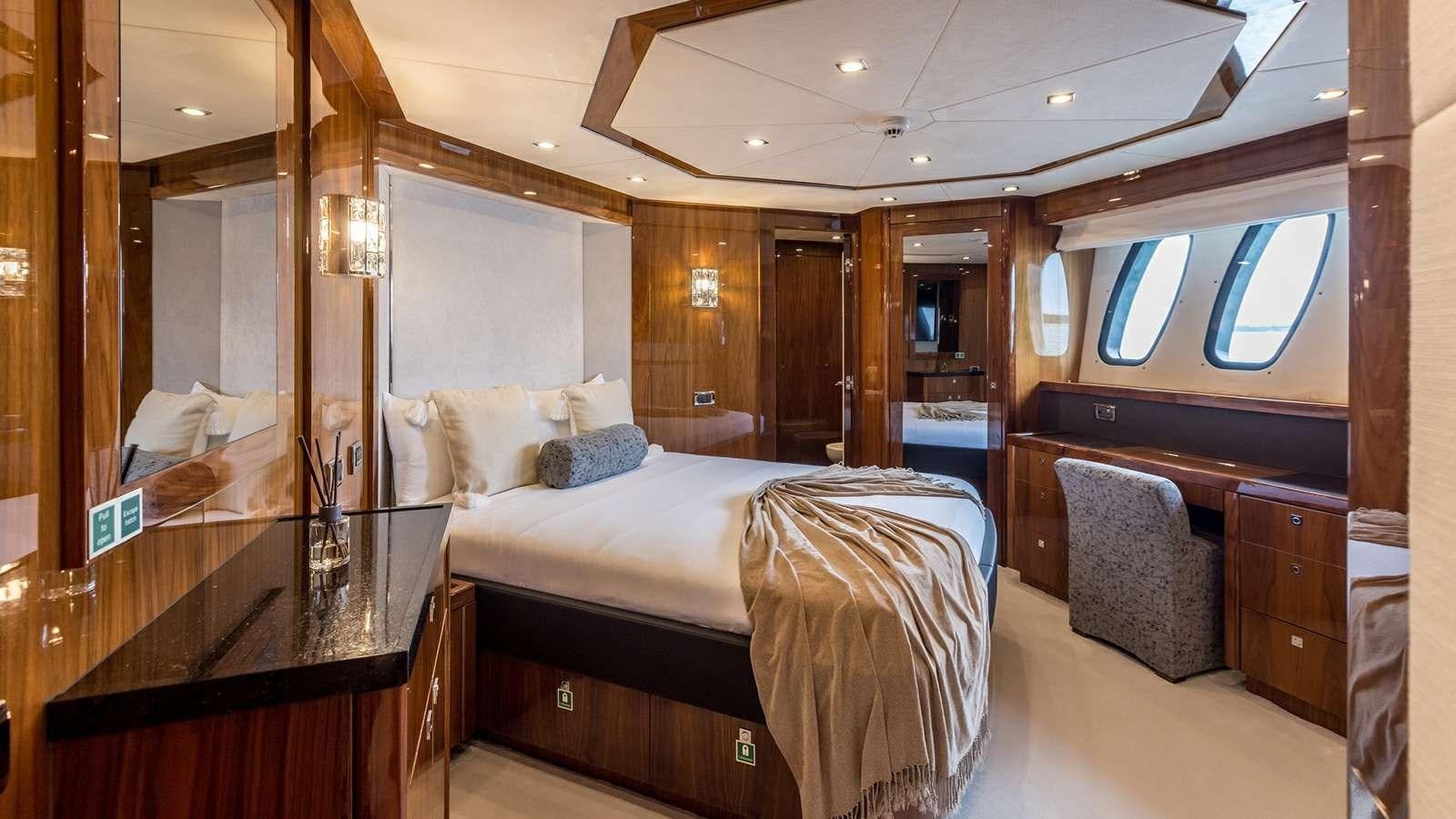 a room with a bed and a desk aboard KATARIINA I Yacht for Sale