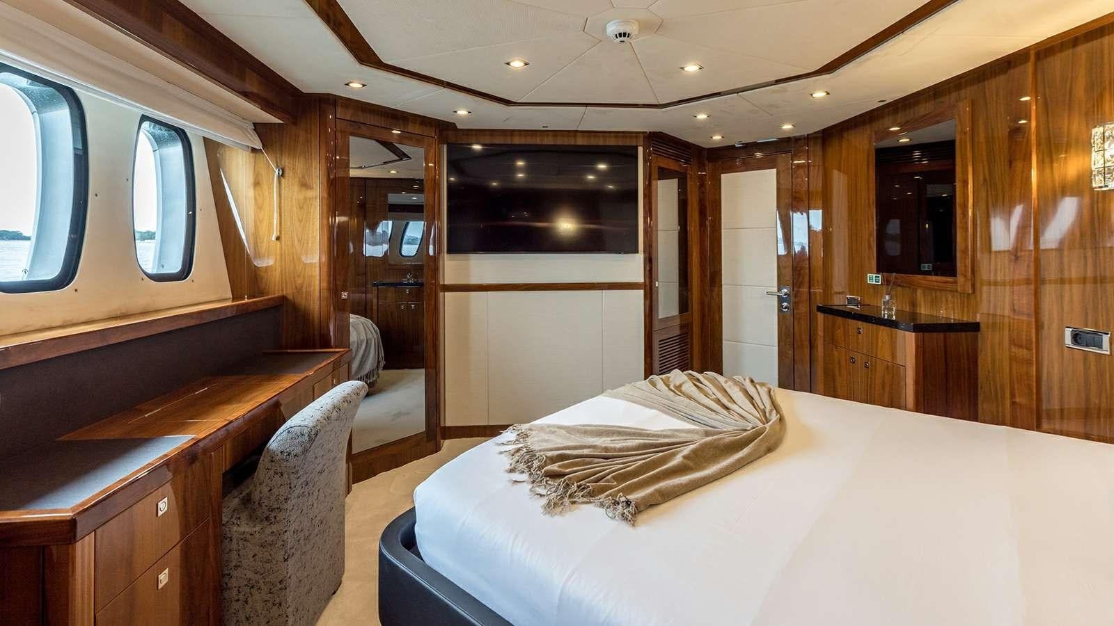 a room with a bed and a desk aboard KATARIINA I Yacht for Sale