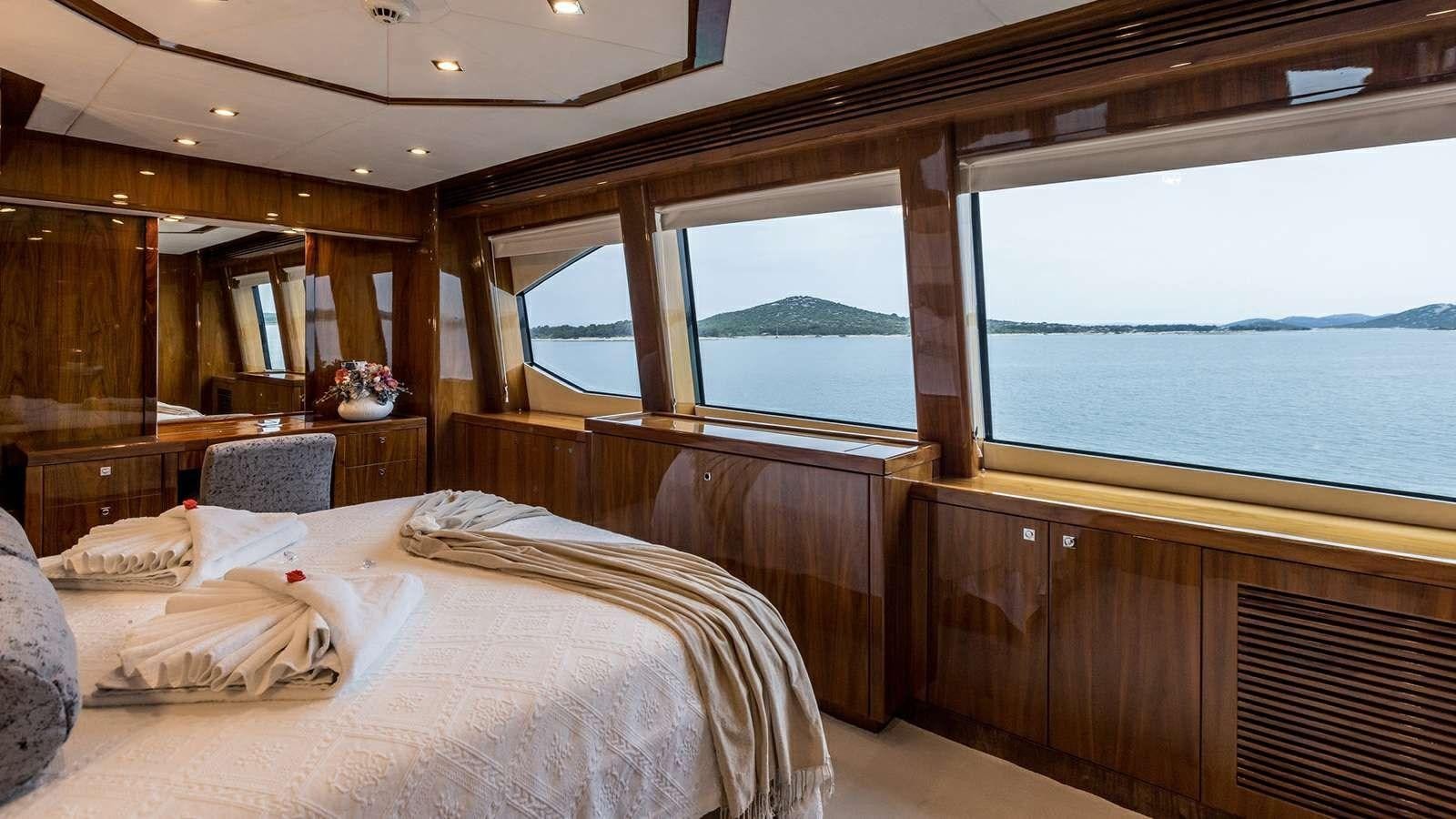 a room with a bed and a window aboard KATARIINA I Yacht for Sale