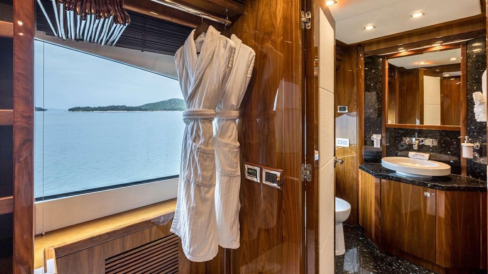 a bathroom with a robe on the wall aboard KATARIINA I Yacht for Sale