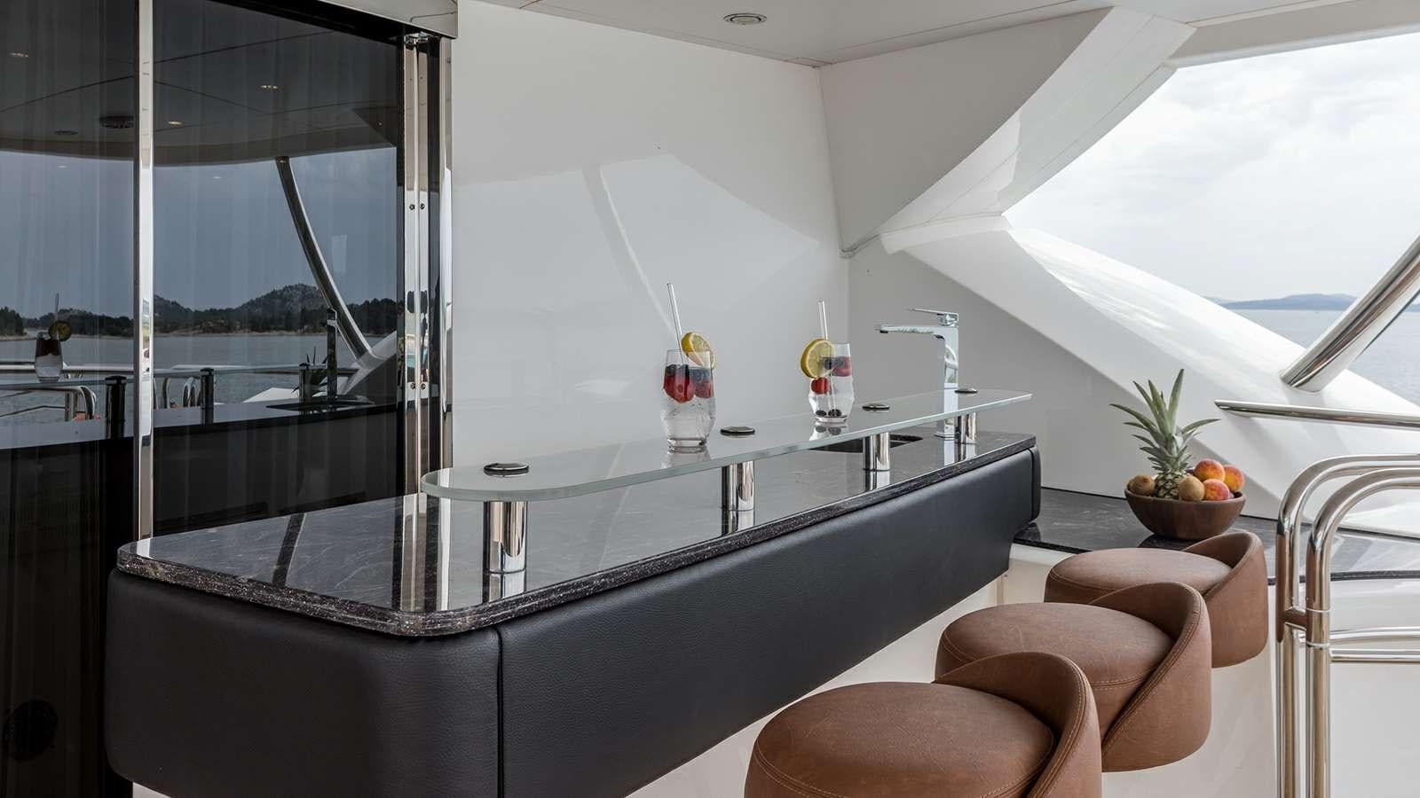 a room with a glass table and chairs aboard KATARIINA I Yacht for Sale