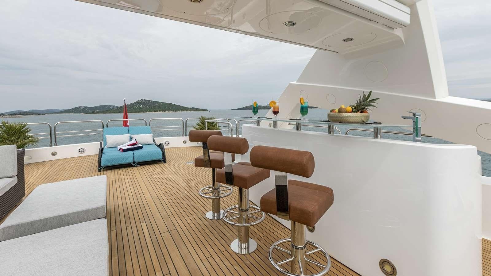 a room with a table chairs and a pool aboard KATARIINA I Yacht for Sale