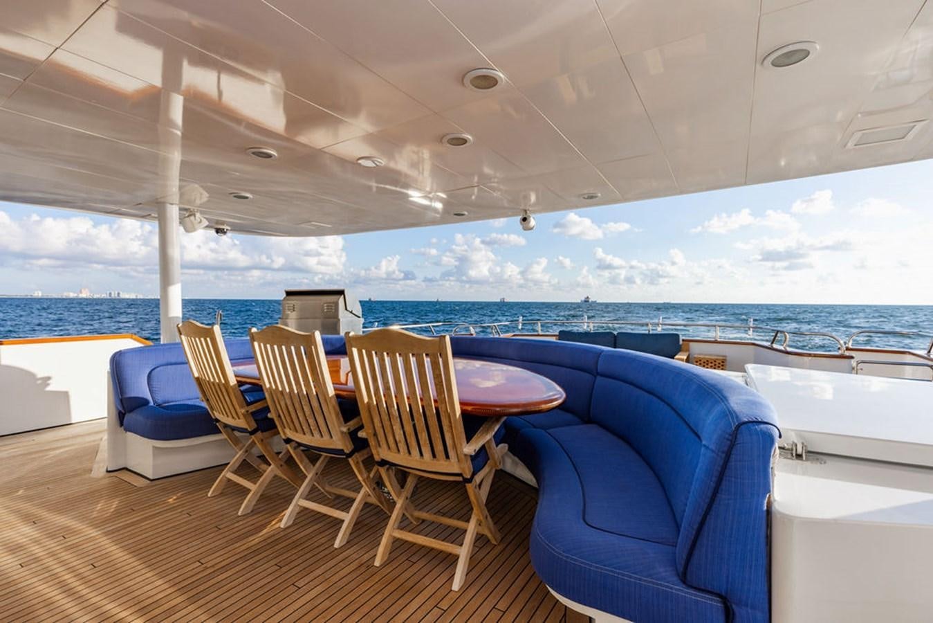 a room with a table chairs and a large window overlooking the ocean aboard EMPIRE SEA Yacht for Sale