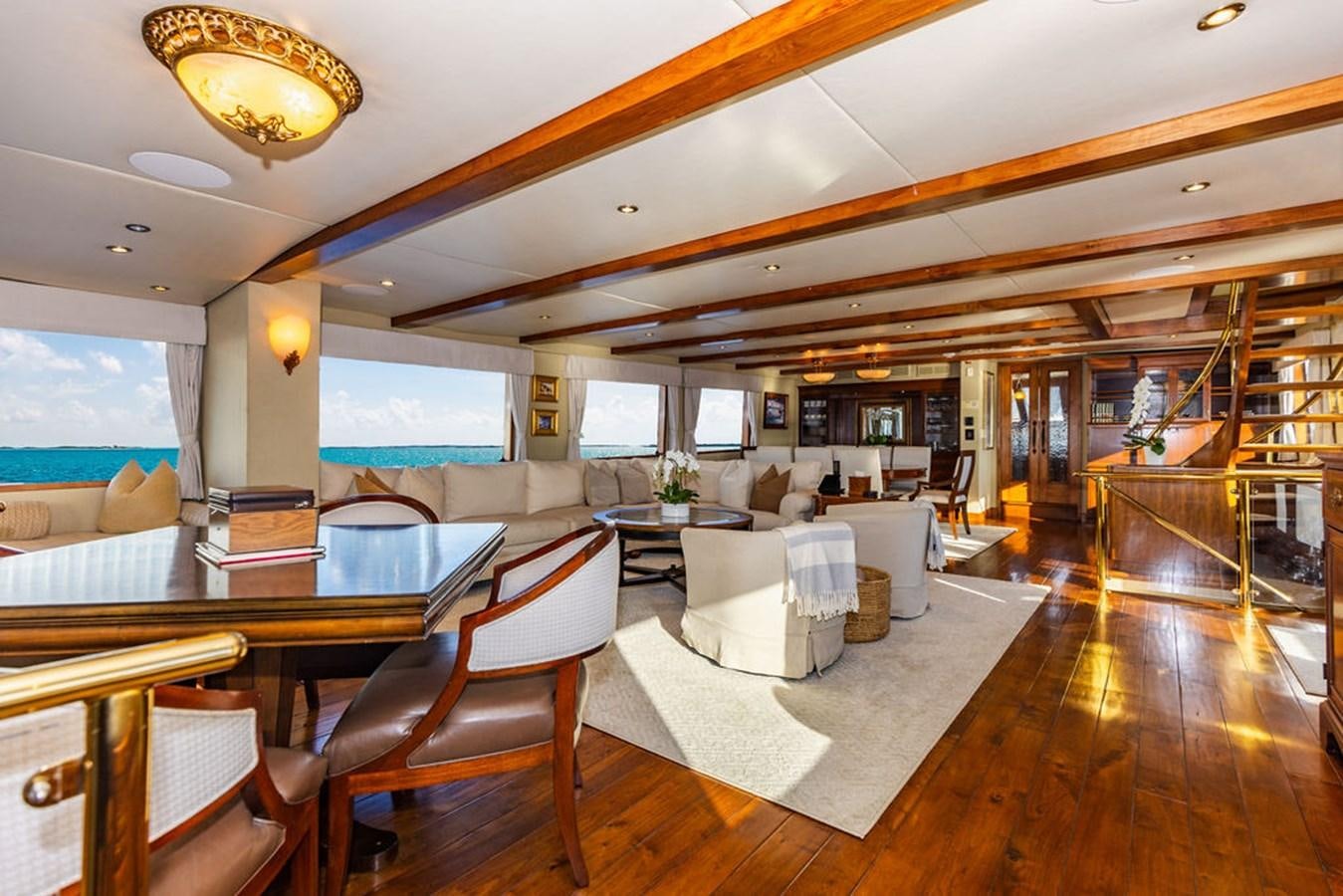 a room with a table chairs and a large window aboard EMPIRE SEA Yacht for Sale