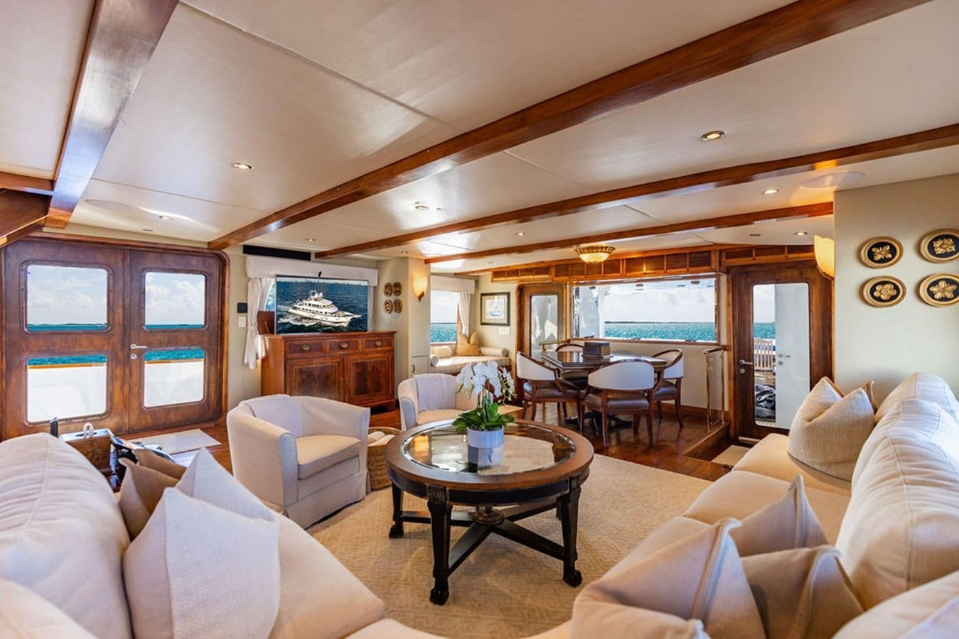 a living room with a table and chairs aboard EMPIRE SEA Yacht for Sale