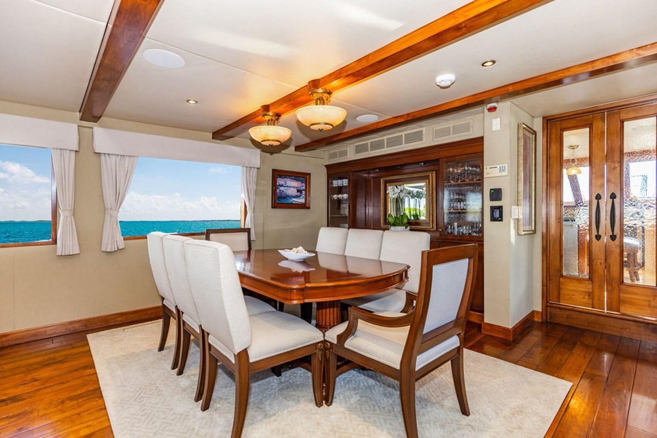a dining room with a table and chairs aboard EMPIRE SEA Yacht for Sale