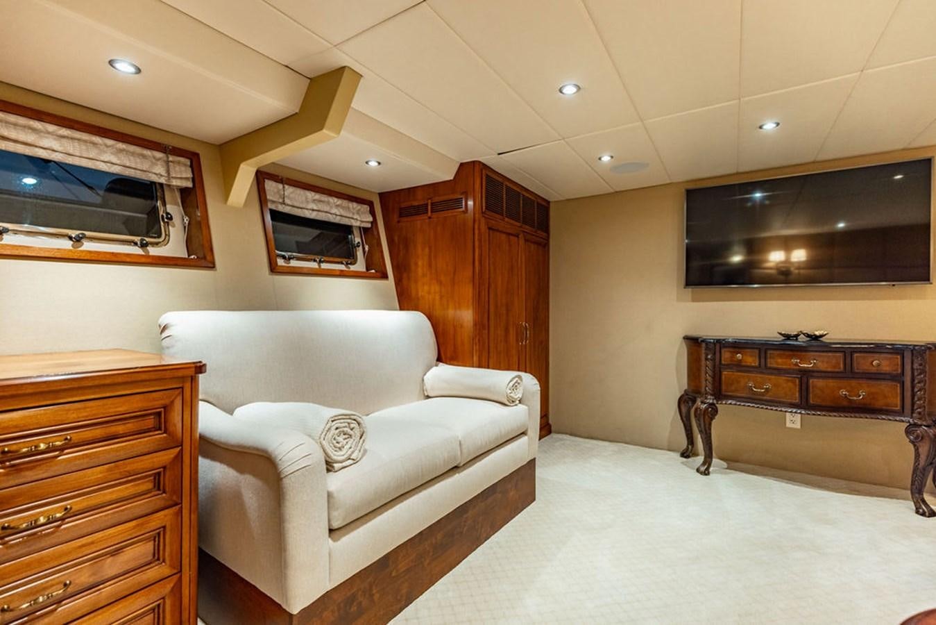 a living room with a couch and a television aboard EMPIRE SEA Yacht for Sale