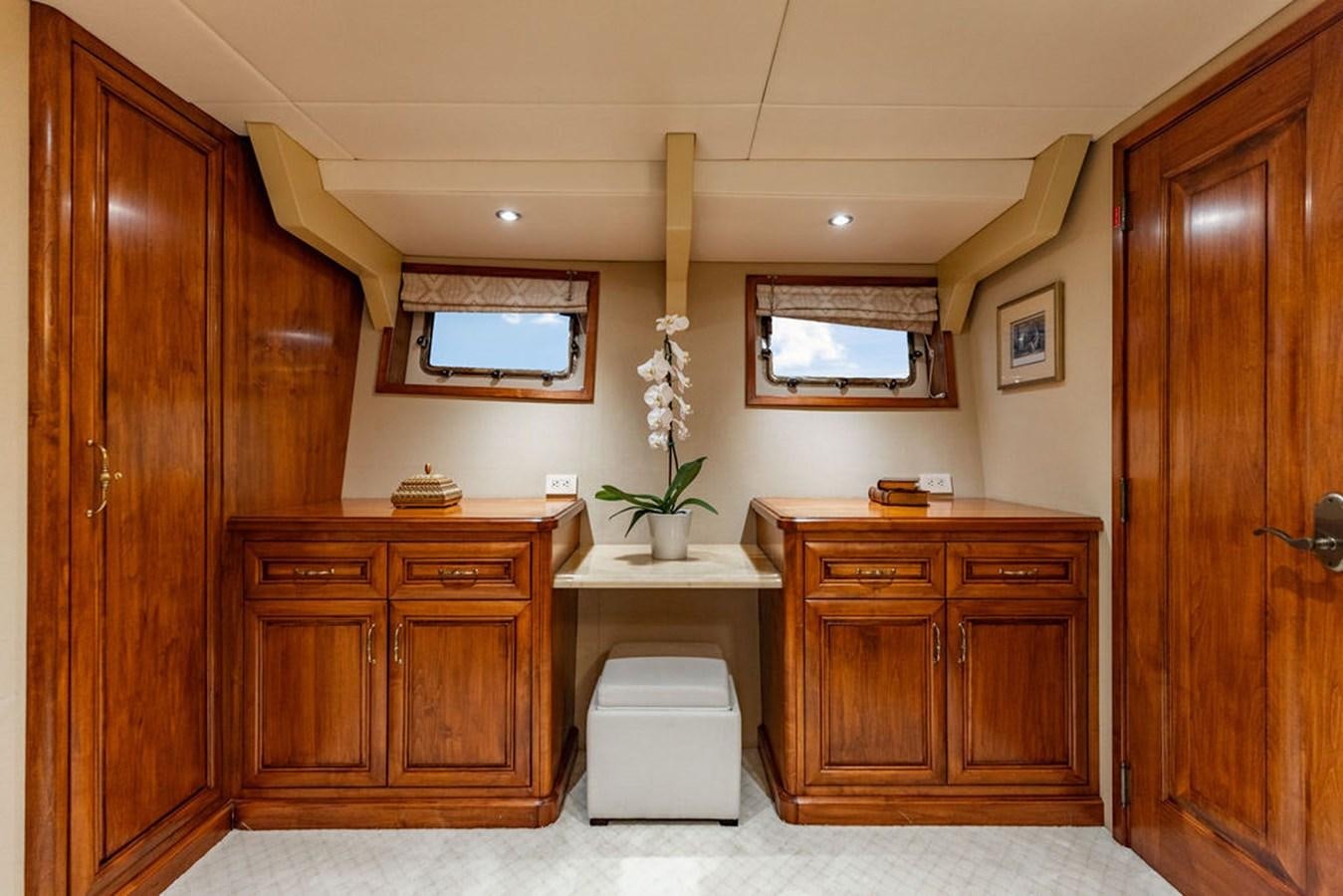 a room with wooden cabinets and a white chair aboard EMPIRE SEA Yacht for Sale